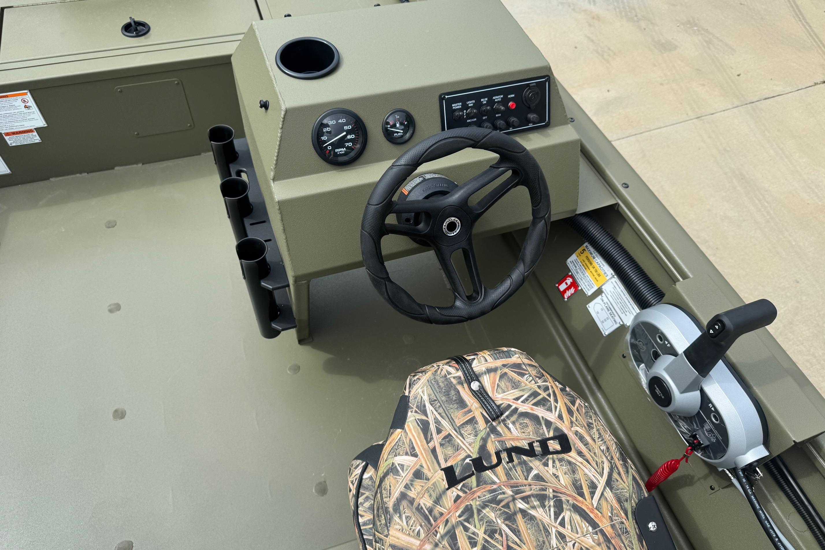 2026 Lund 1760 Predator SC boat interior with steering wheel and control panel.