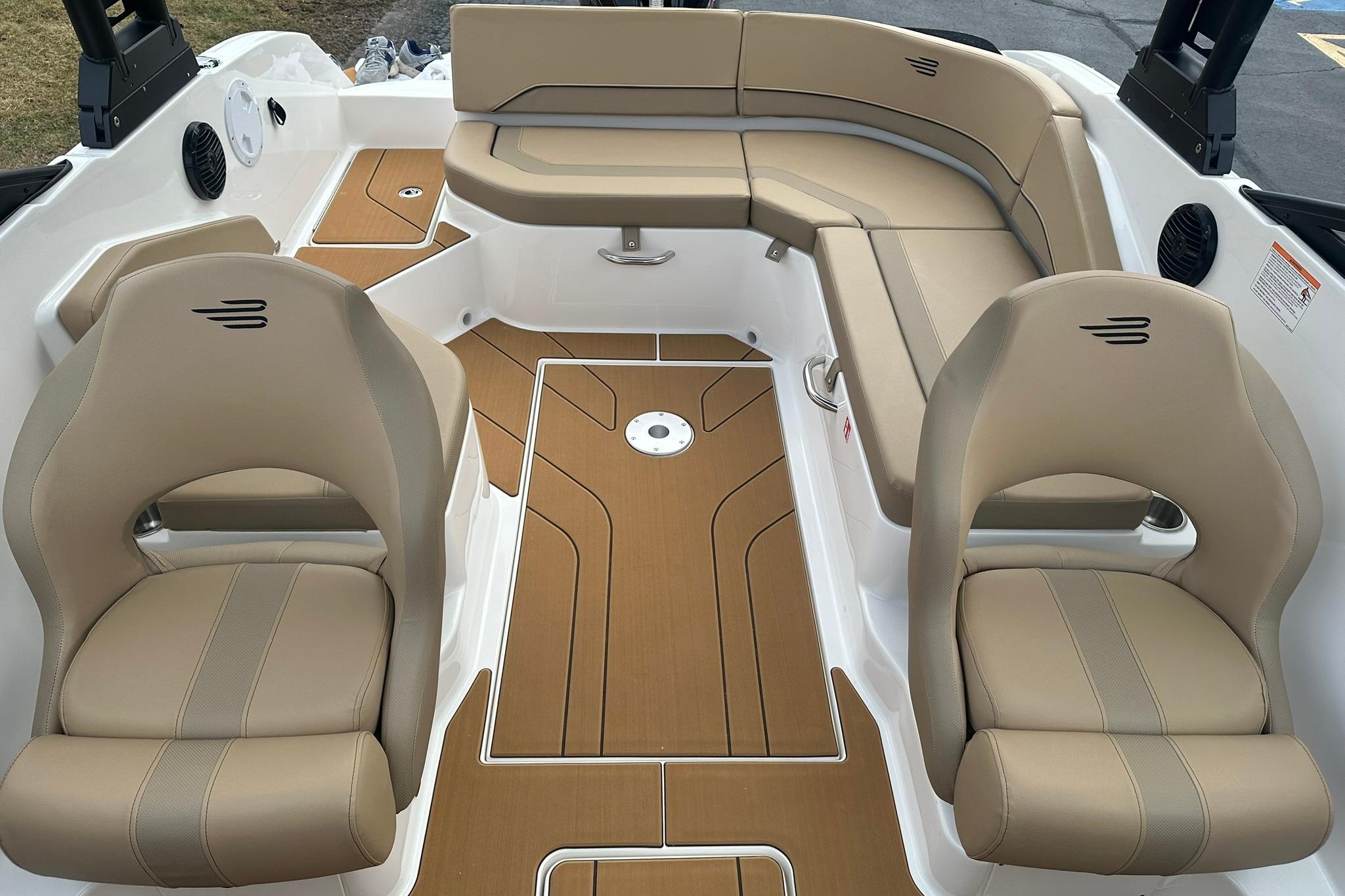 2026 Bayliner V20 boat interior with beige seating and wood-style flooring.