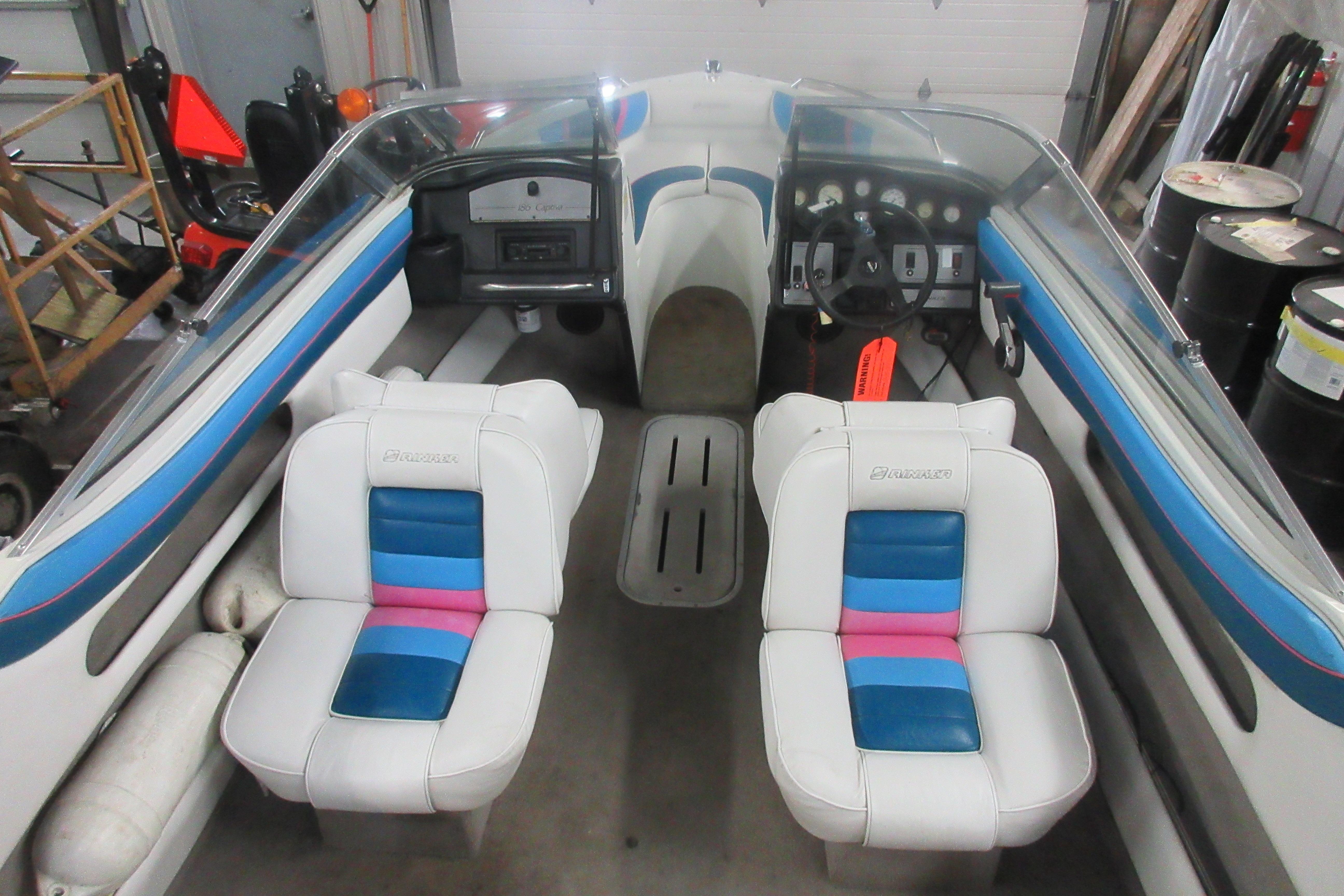 1993 Rinker 186 Captiva Bowrider interior with colorful seating and dashboard controls.