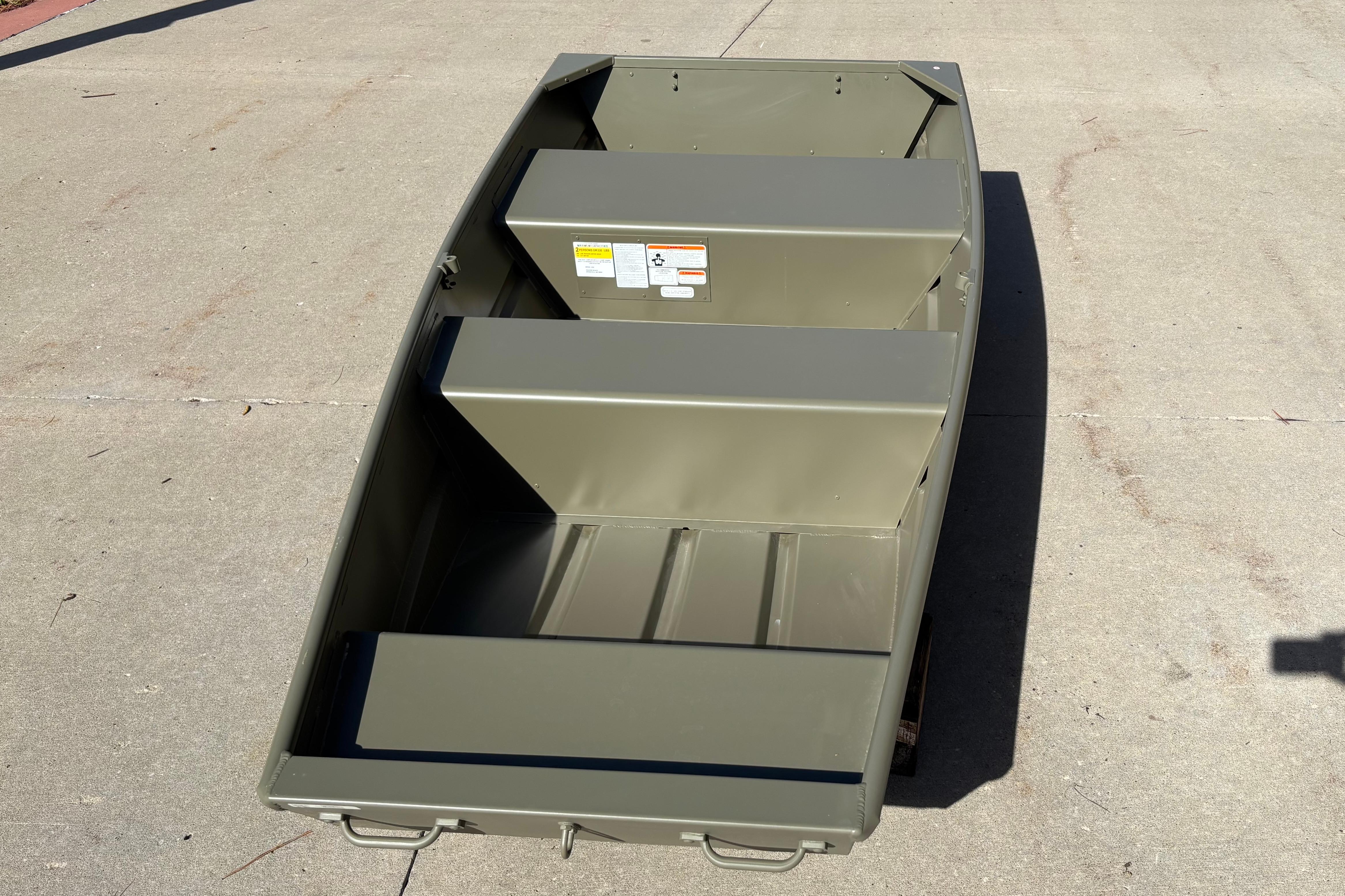 2026 Tracker Grizzly 10 Jon boat on concrete surface, showcasing interior seating and design.
