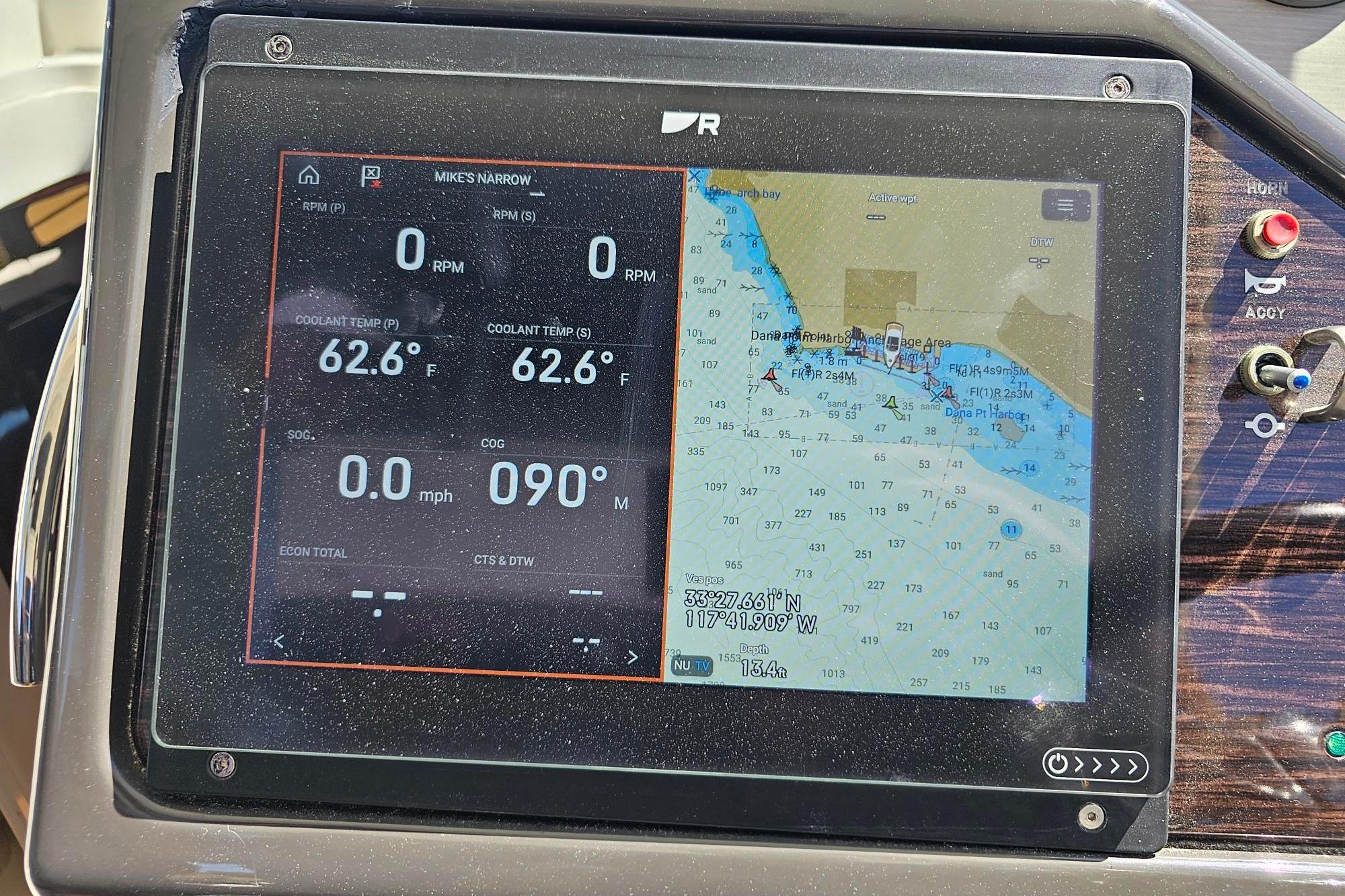 Dashboard of a 2016 Sea Ray Sundancer 350 with navigation and engine data display.