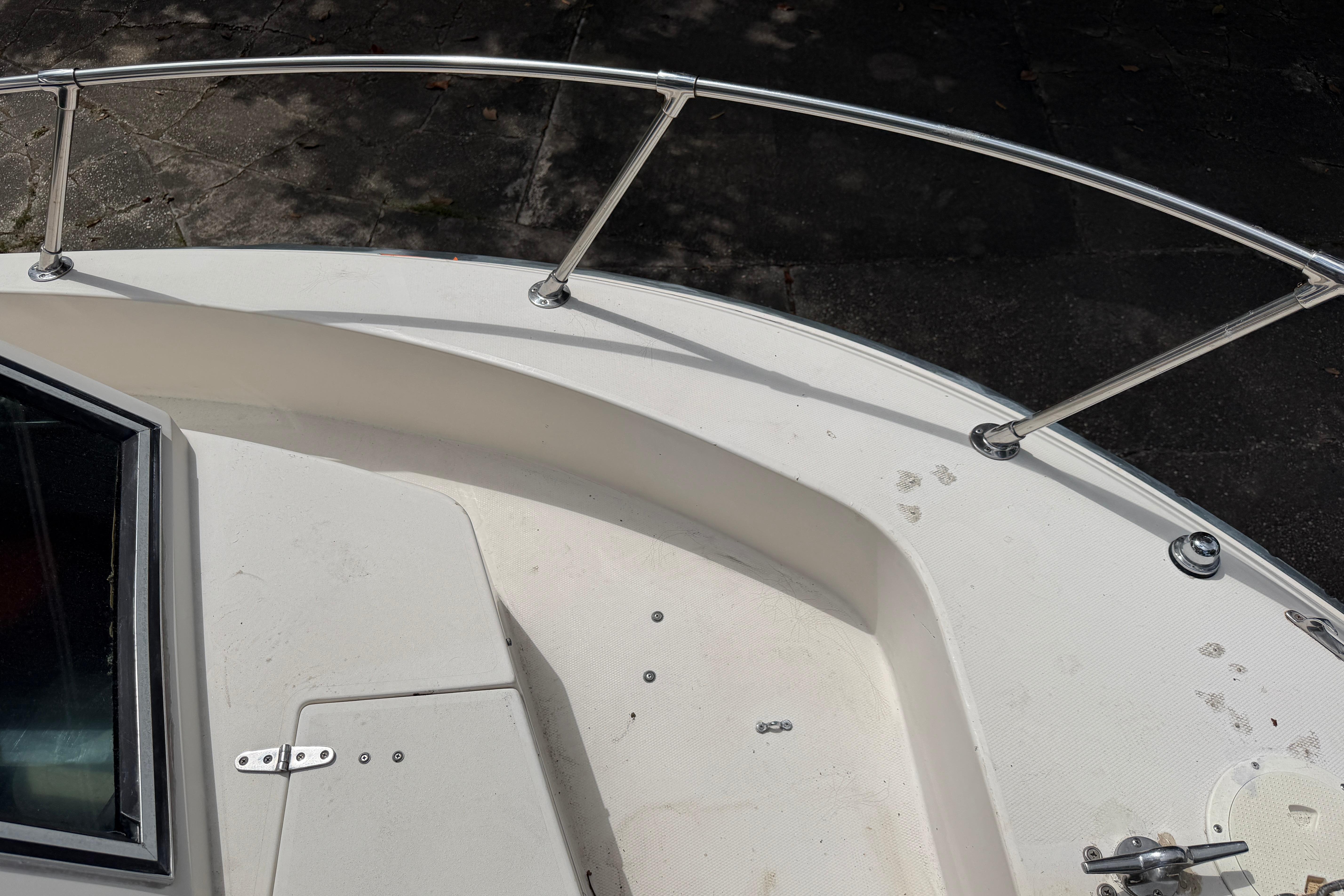 1987 Grady-White Seafarer 226 boat deck with stainless steel railing and hatch.
