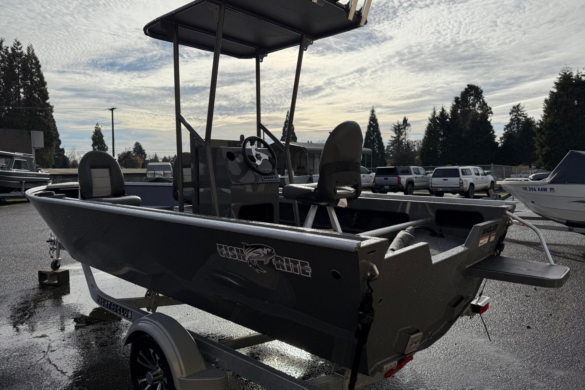 2026 Fish Rite Angler 18 boat on trailer, parked outdoors under cloudy sky.