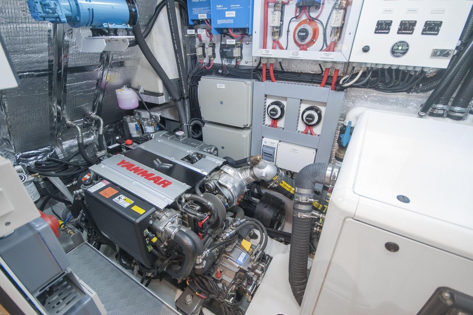 Engine room of 2025 MCP Global Exp 68 yacht with Yanmar engine and control systems.