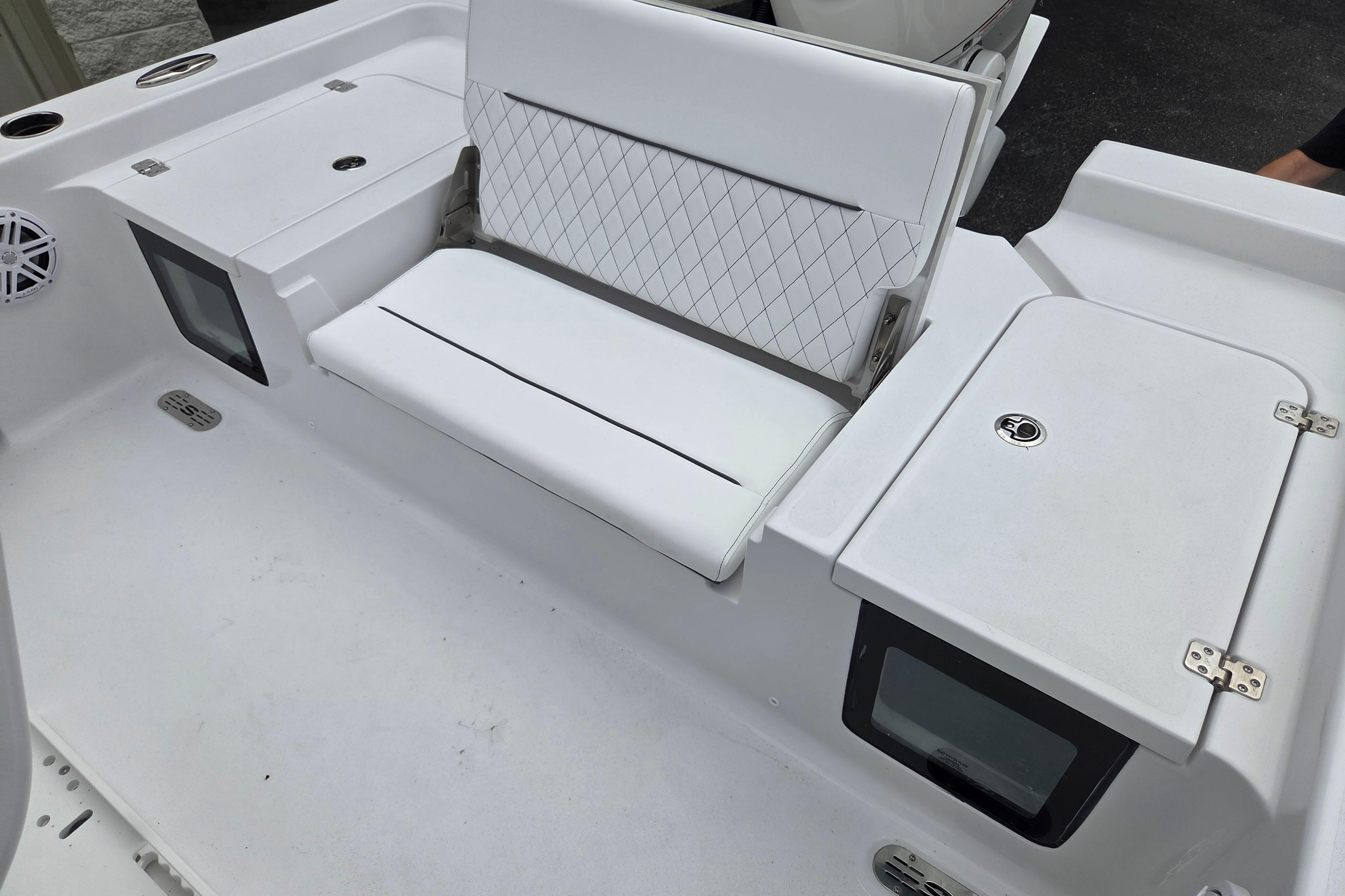 2026 Sportsman Masters 247 Bay Boat interior with white seating and storage compartments.