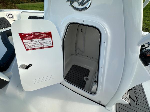 2024 Tidewater 232 SS boat storage compartment with open door.