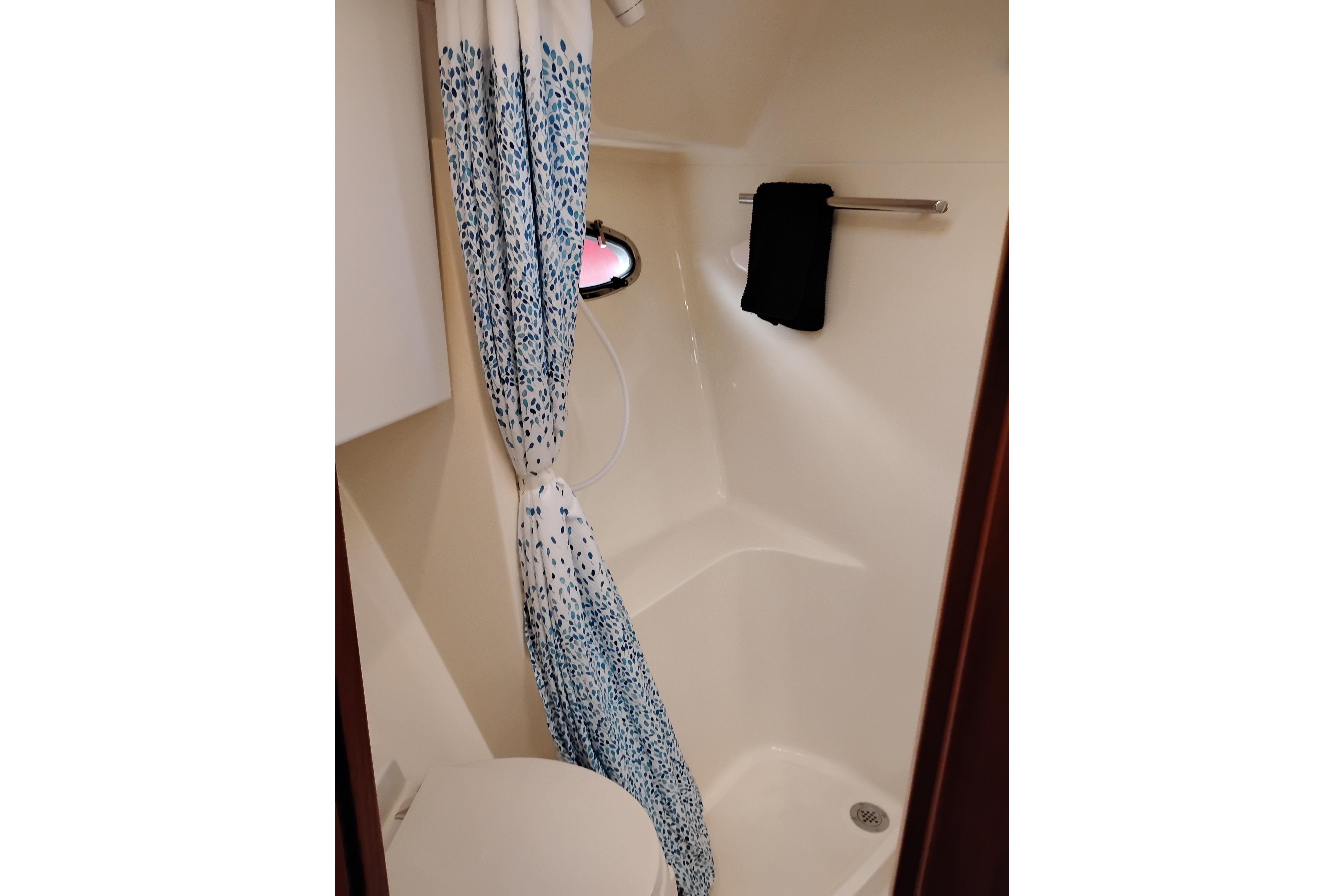 Bathroom interior of 1997 Tiara 3700 Open yacht with shower and curtain.