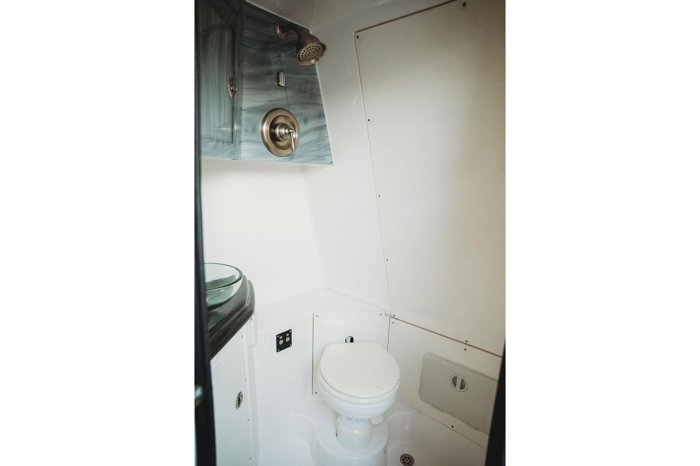 Compact bathroom in 2018 MTI 57 boat with modern fixtures and sleek design.