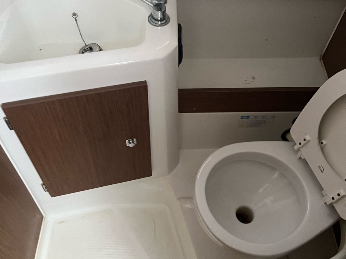 Bathroom with sink and toilet on a boat.