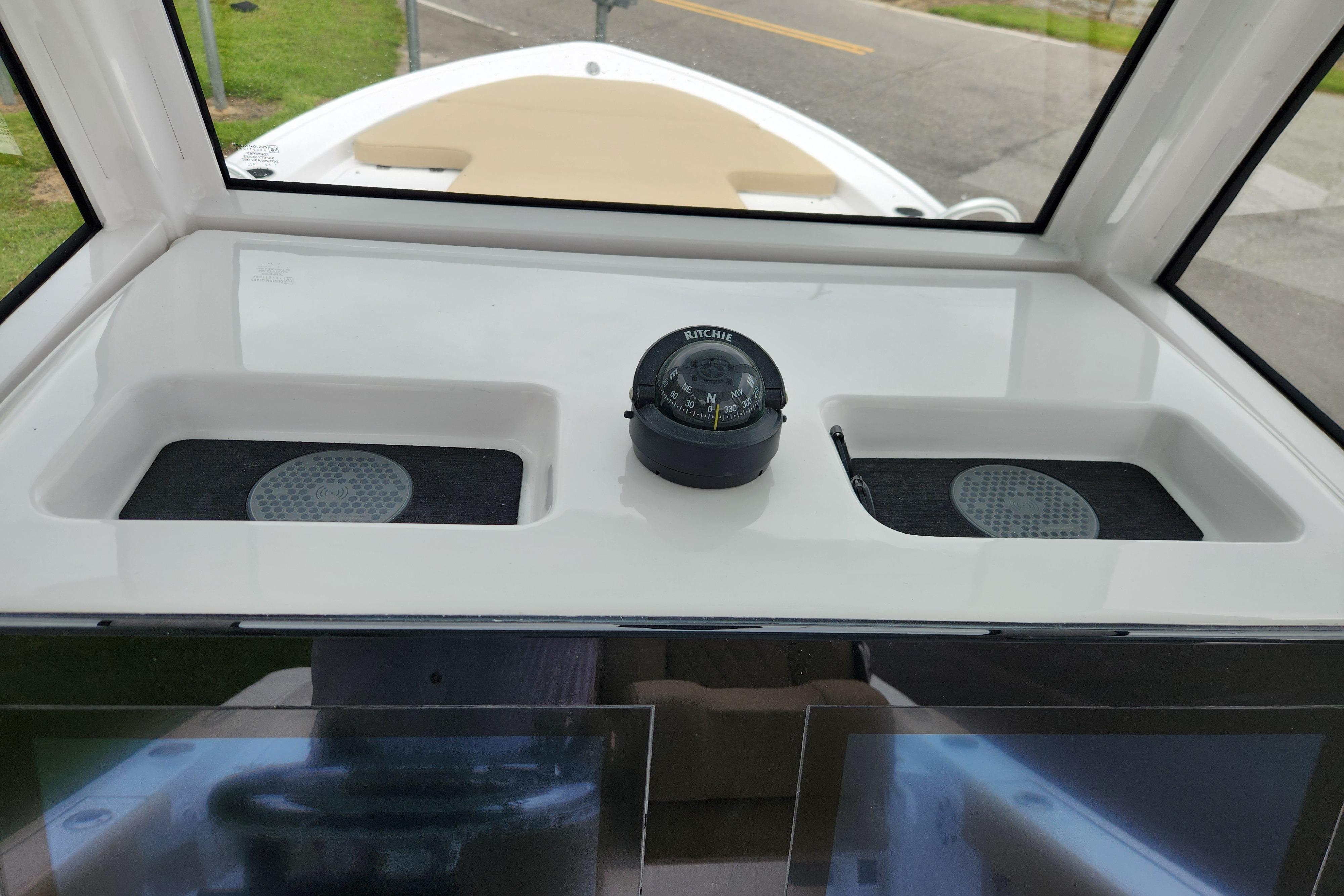 2026 Sportsman Masters 247 Bay Boat dashboard with compass and storage compartments.