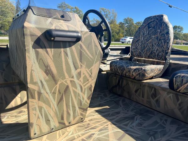 2025 Lowe Roughneck 2070 SC boat interior with camouflage design and steering console.
