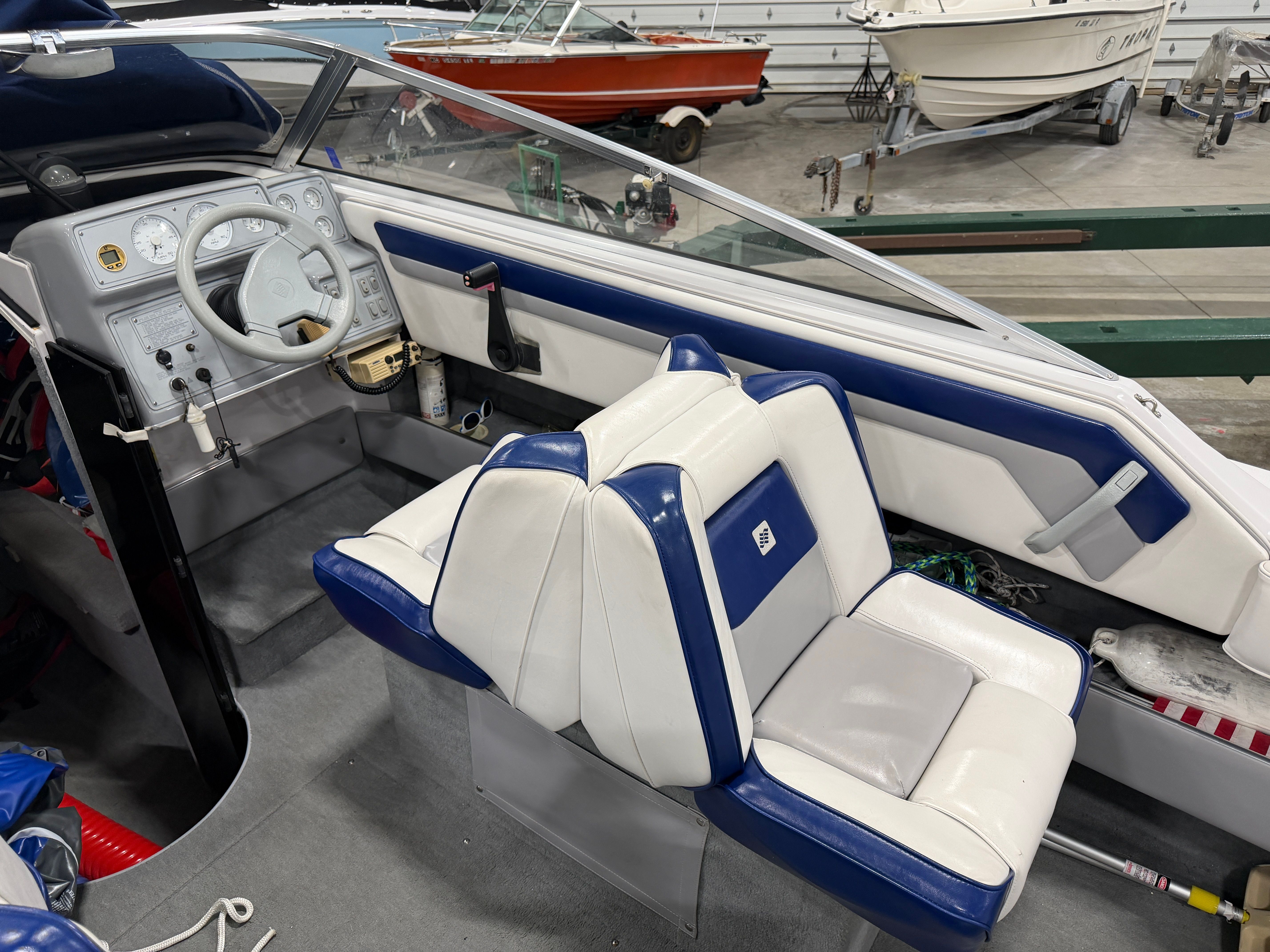 Interior view of a 1992 Four Winns 225 Sundowner with blue and white seating.