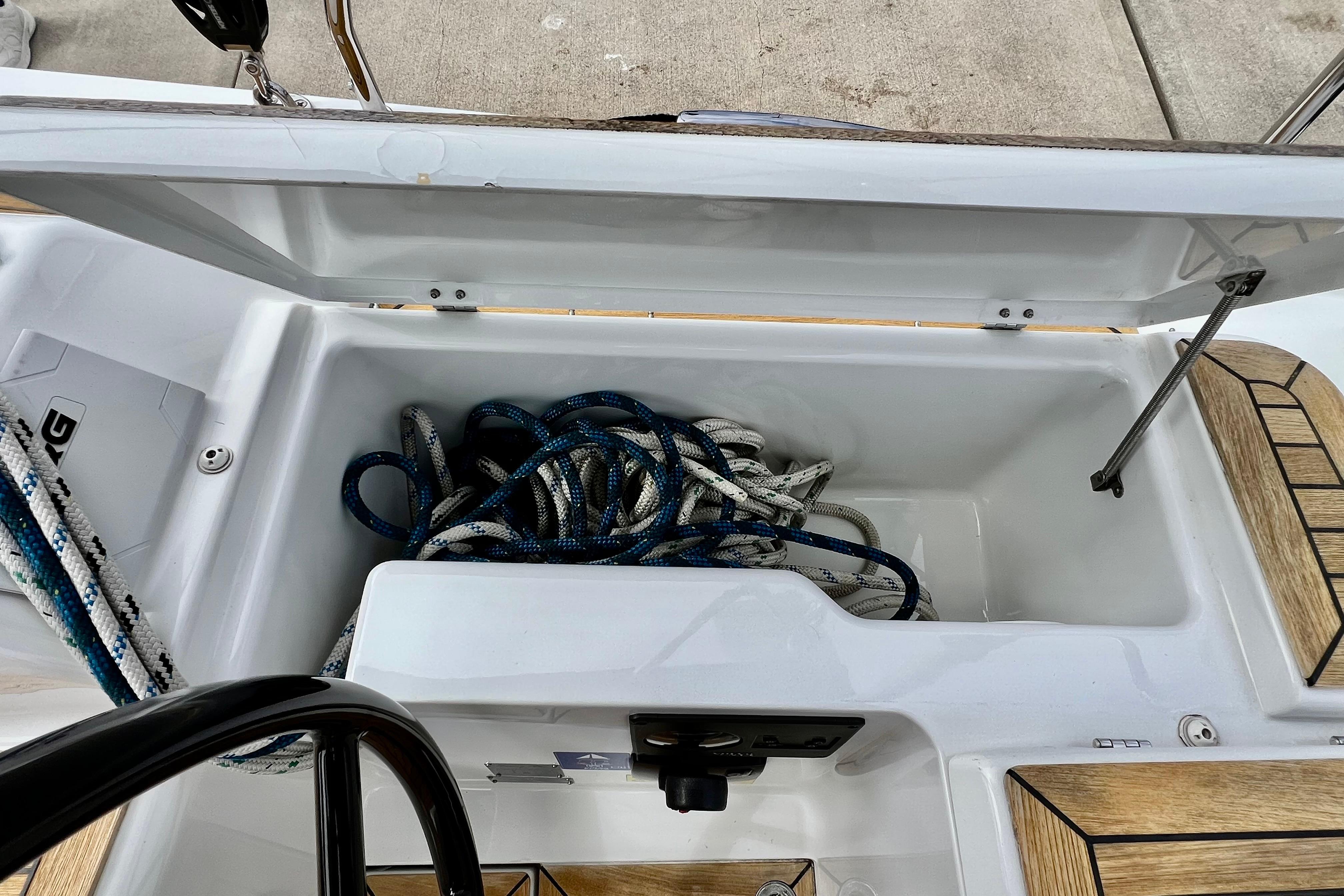 Storage compartment with ropes on a 2016 Hanse 455 sailboat deck.
