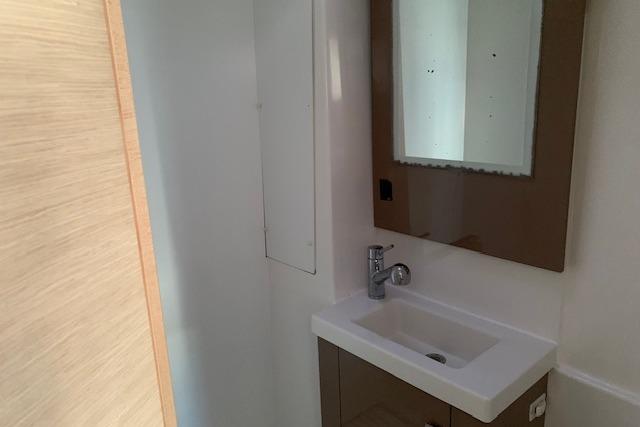 Bathroom interior of 2018 Fountaine Pajot Astrea 42 catamaran with modern sink and mirror.