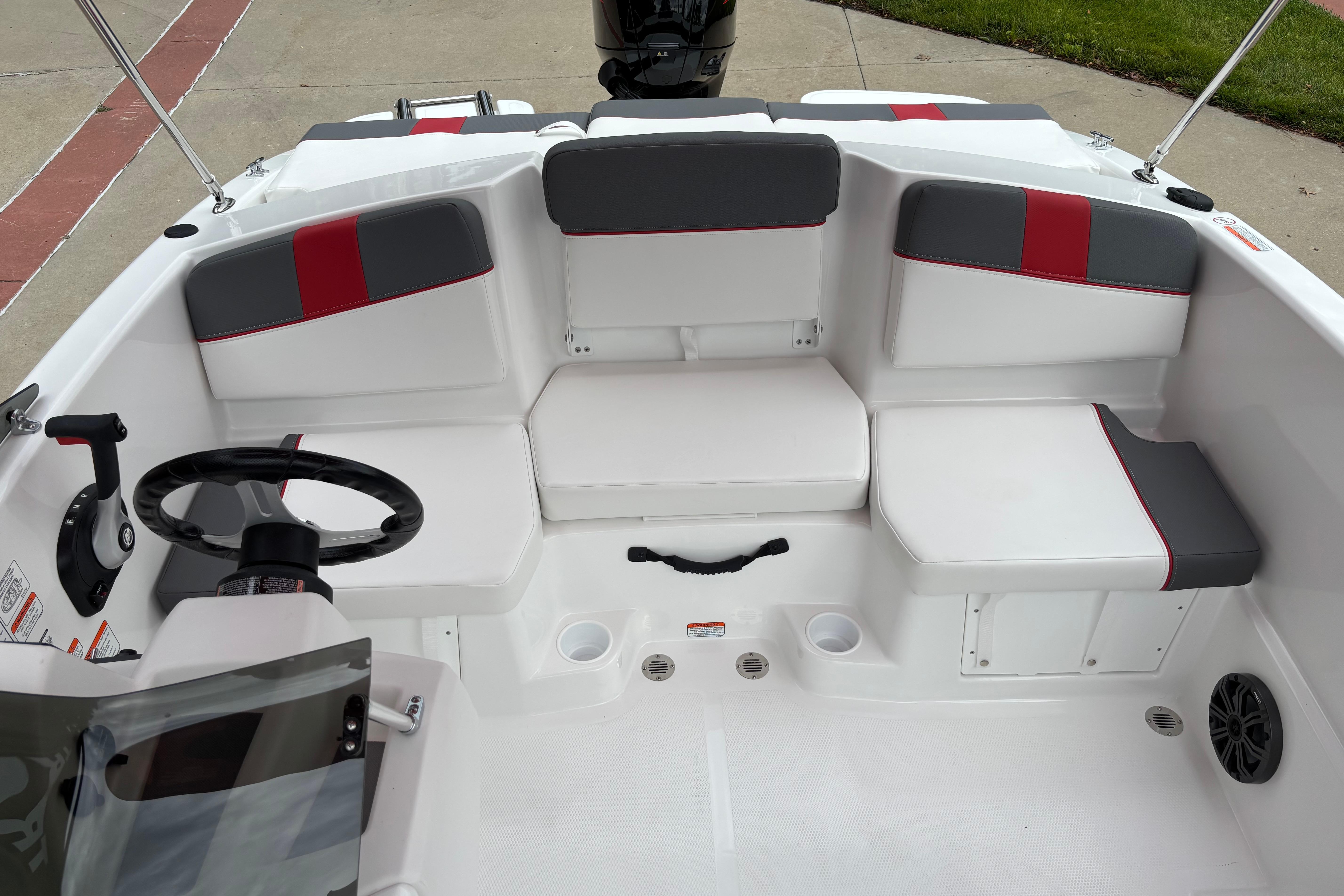 2026 Tahoe T16 boat interior with white and gray seating, red accents, and steering wheel.