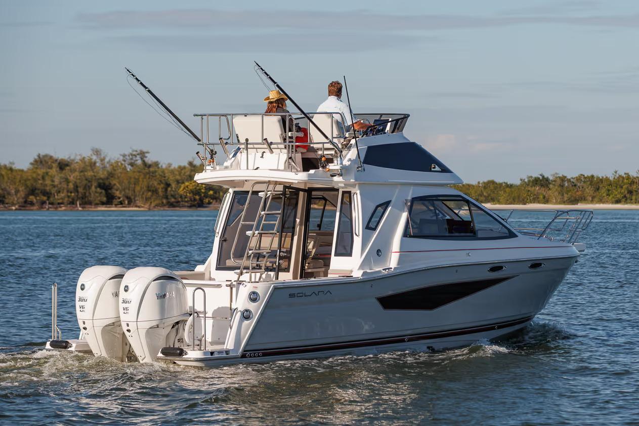 Manufacturer Provided Image: 2026 Solara S-310 SB boat cruising on a calm lake with two passengers.