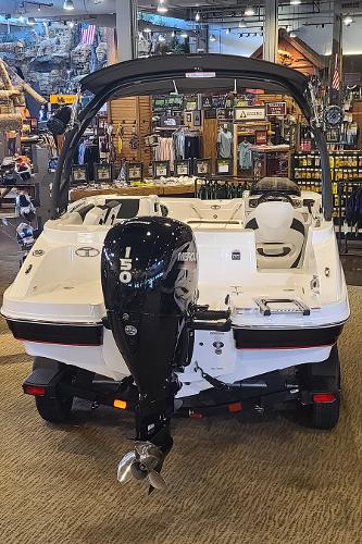 2023 Tahoe 1950 boat with outboard motor displayed in a showroom.