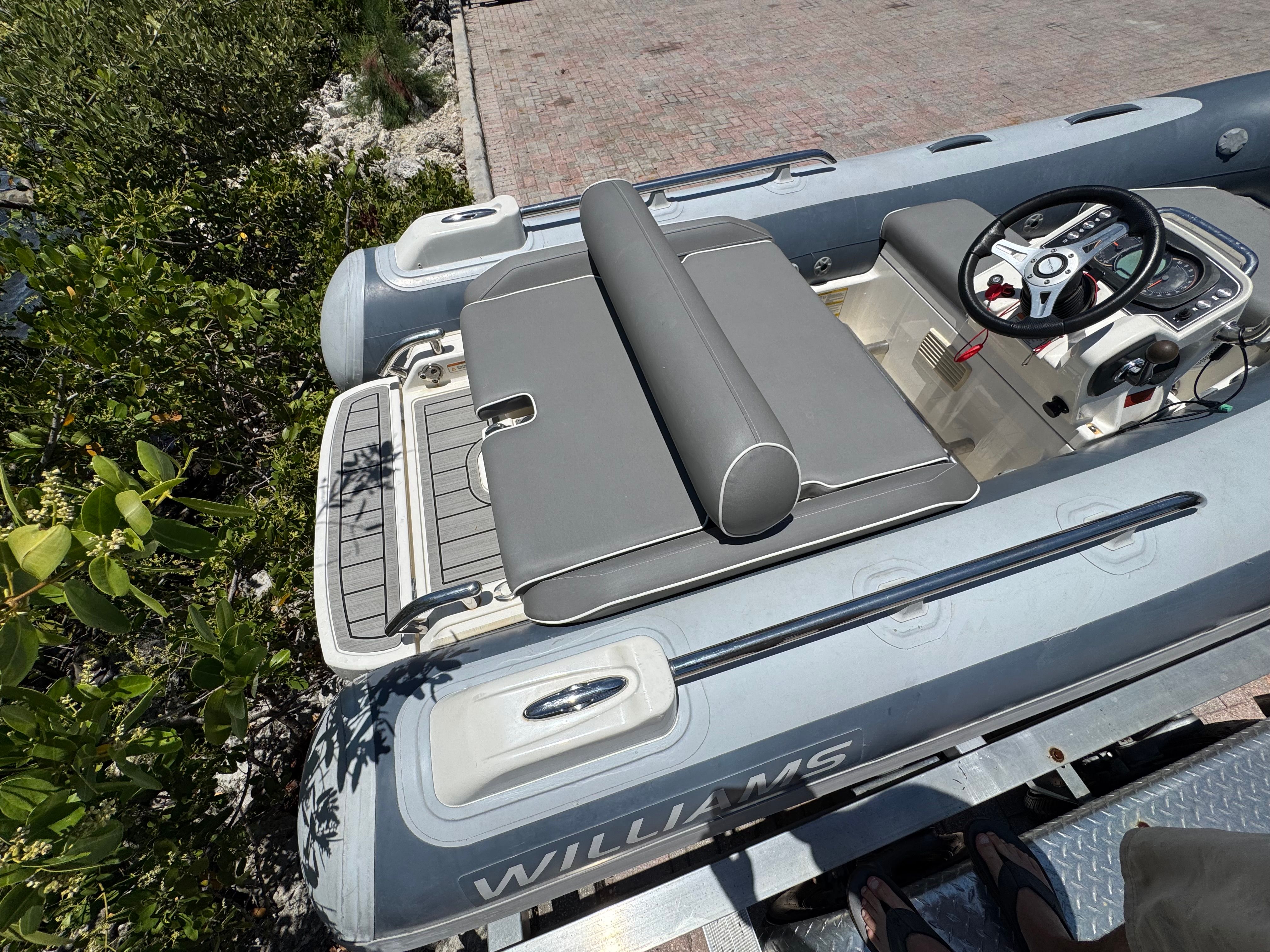 A 2019 Williams Jet Tender Sportjet 345 with gray upholstery and a modern helm station.