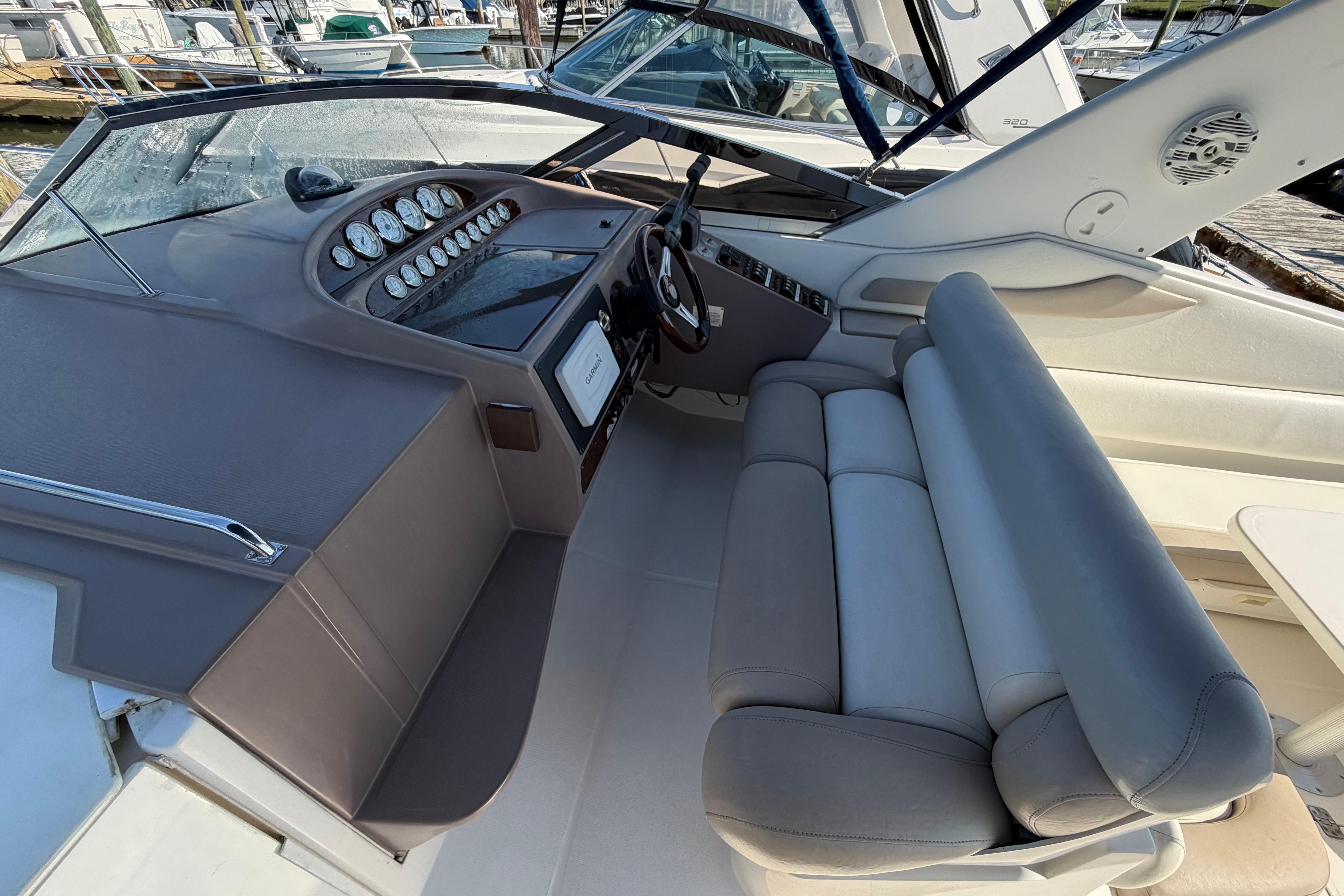 Interior view of a 2003 Regal Commodore 3260 boat cockpit with dashboard and seating.