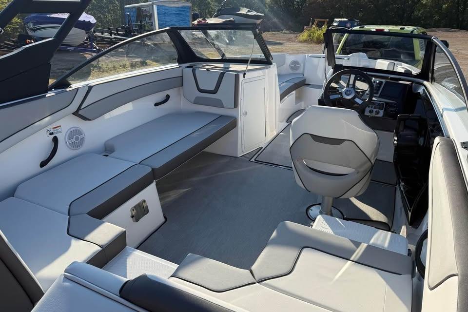 2026 Yamaha Boats AR220 interior with modern seating and steering console.
