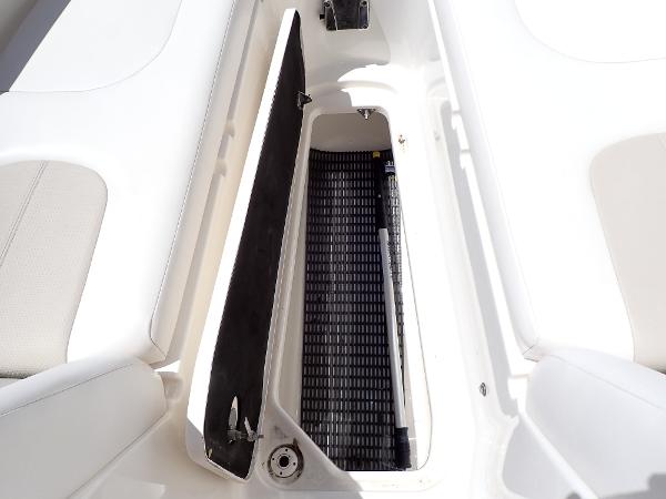 Open storage compartment on 2011 Chaparral 287 SSX boat, featuring white interior design.