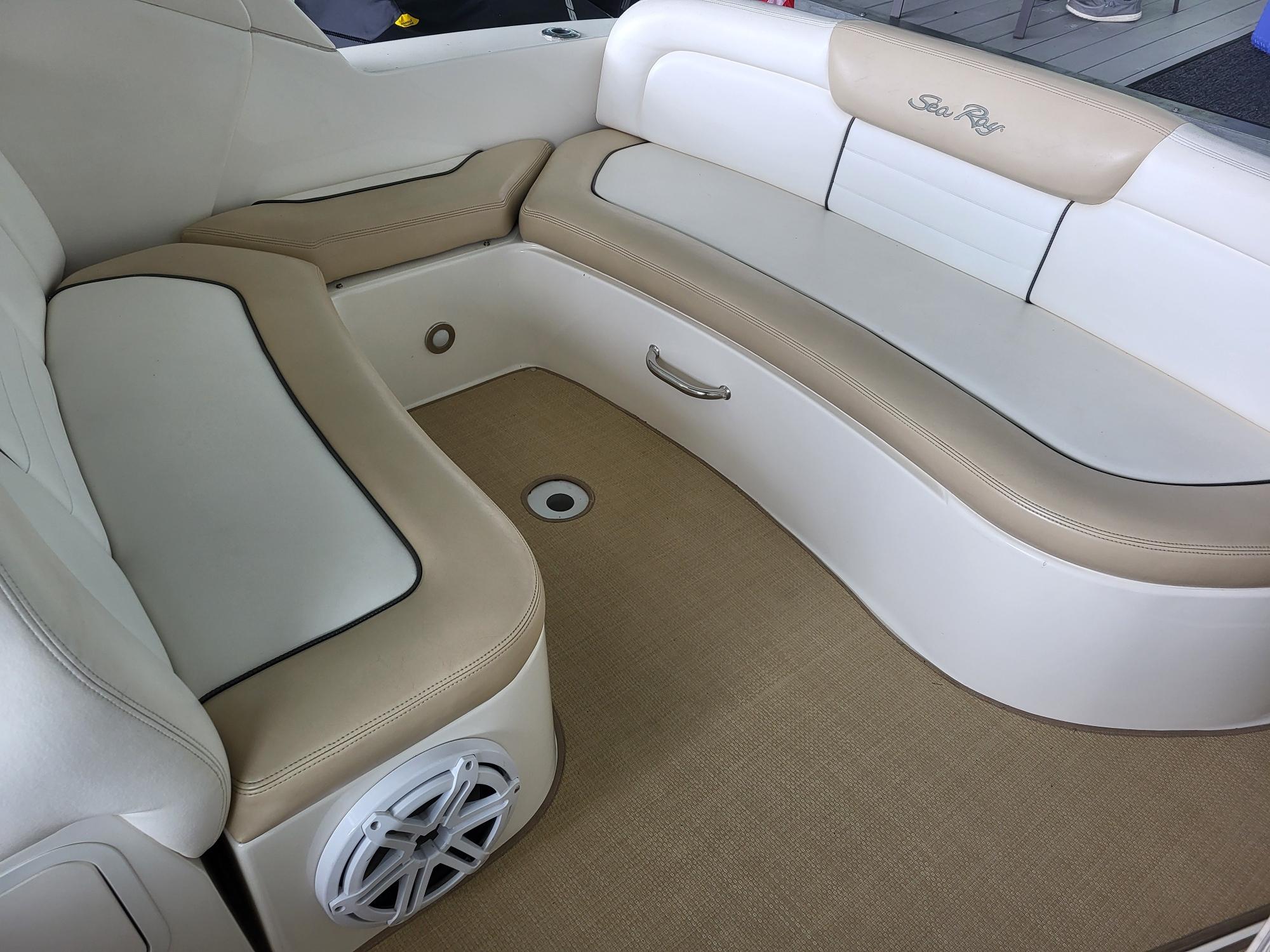 2009 Sea Ray 310 Sundancer interior seating with beige and white upholstery.