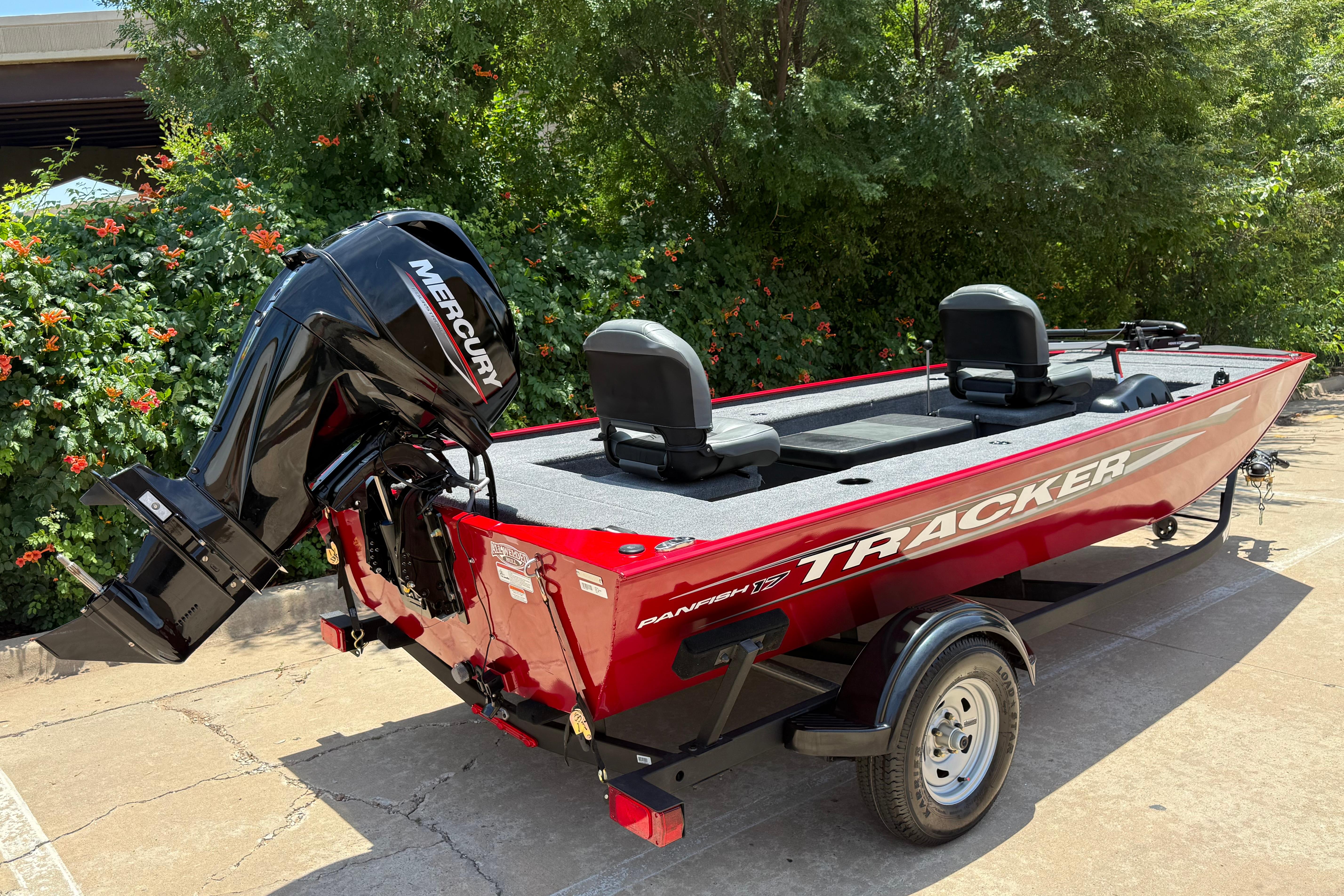 2025 Tracker Panfish 17 boat with Mercury engine, parked outdoors.