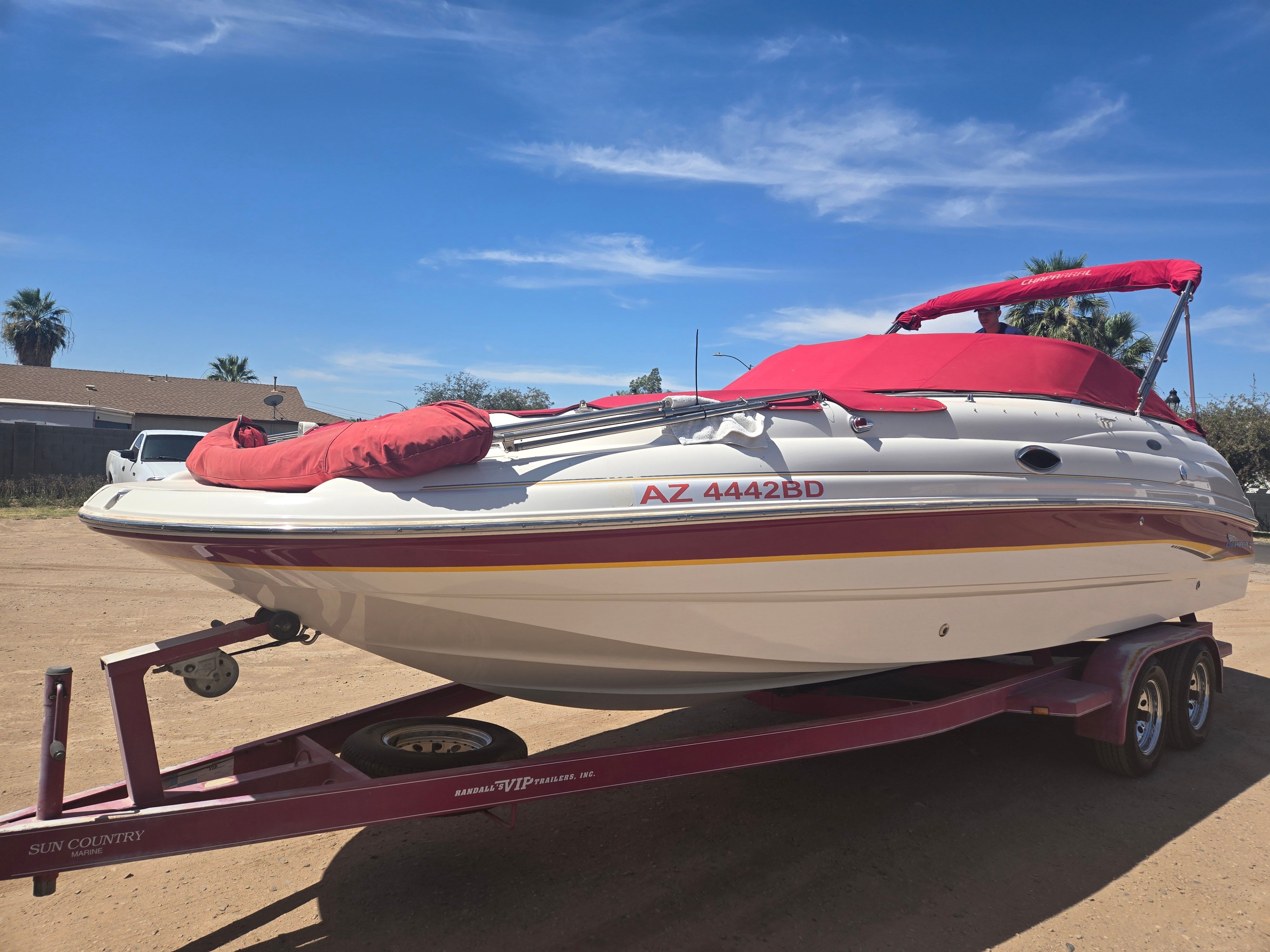 2001 Chaparral Sunesta 233 boat on trailer, red canopy.