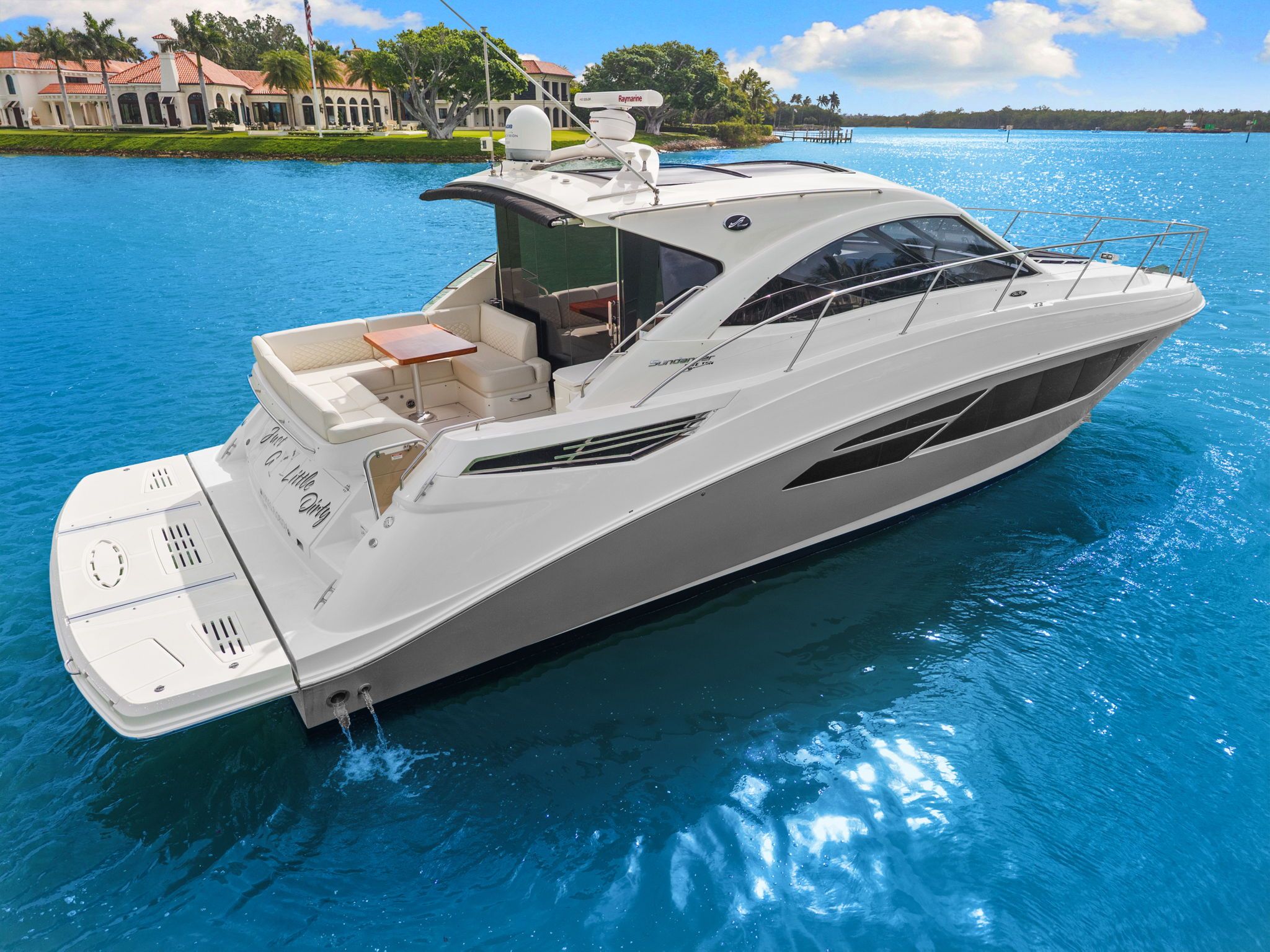 2017 Sea Ray Sundancer 510 on blue water, featuring sleek white cabin and spacious deck.