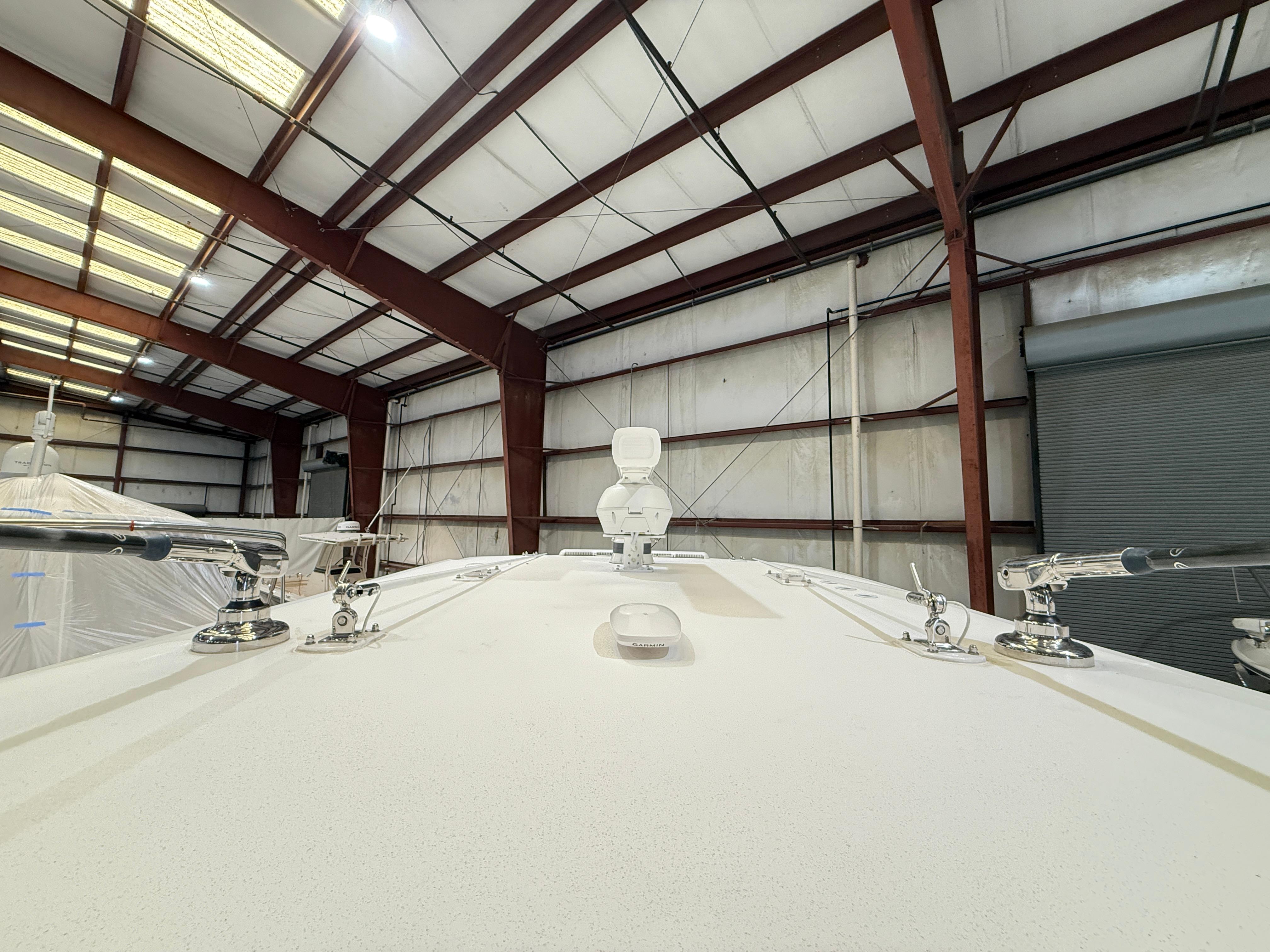 2022 Invincible 39 Open Fisherman boat in a warehouse, viewed from the bow.