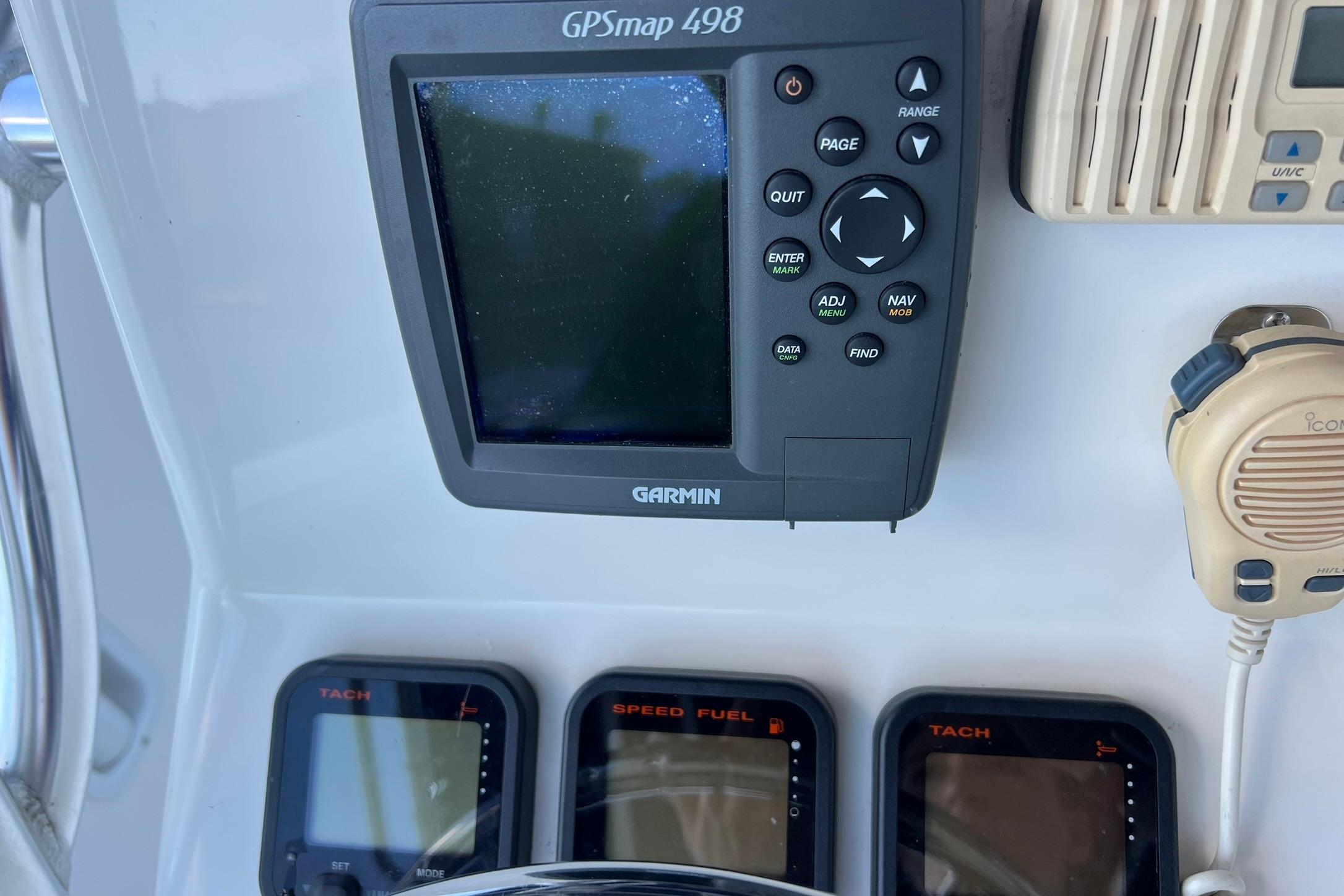 Garmin GPSmap 498 and gauges on 2006 Edgewater 245CC boat dashboard.