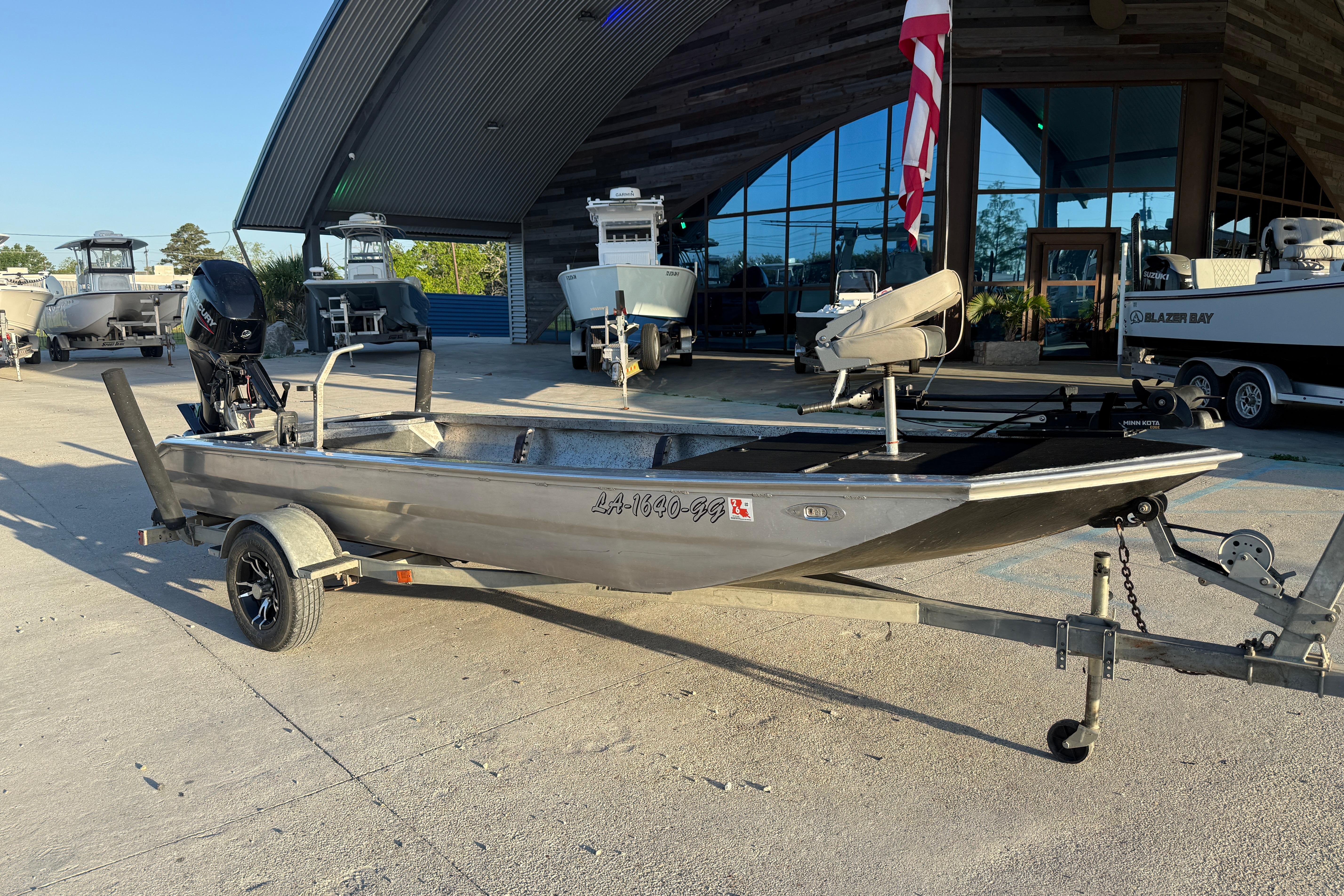 2017 Homemade 1754 boat on trailer, parked outside a showroom.