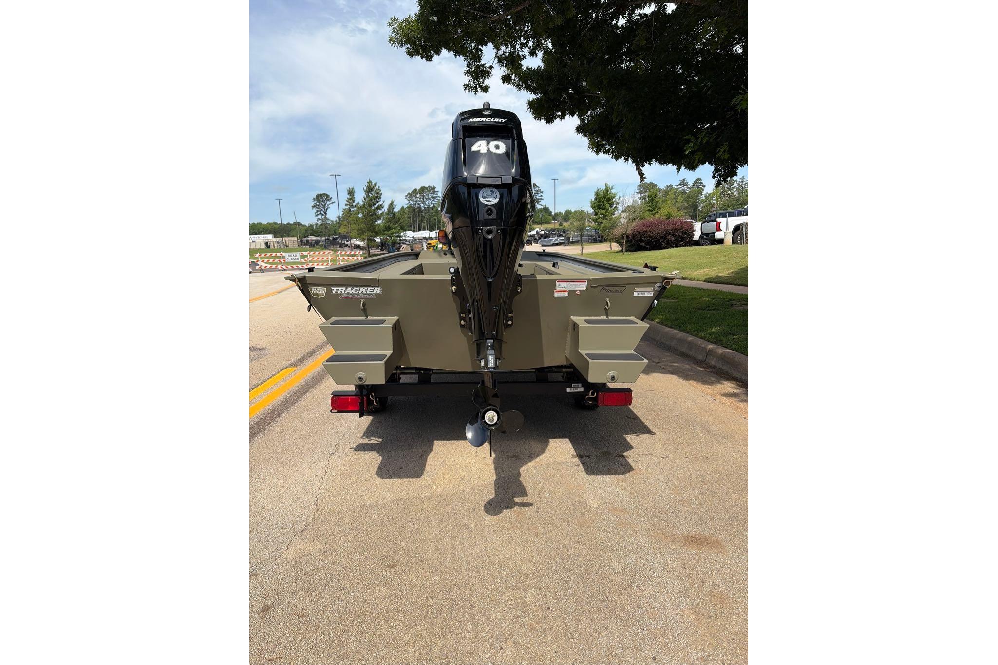2026 Tracker Grizzly 1654 T Sportsman boat with Mercury 40 engine on a road.