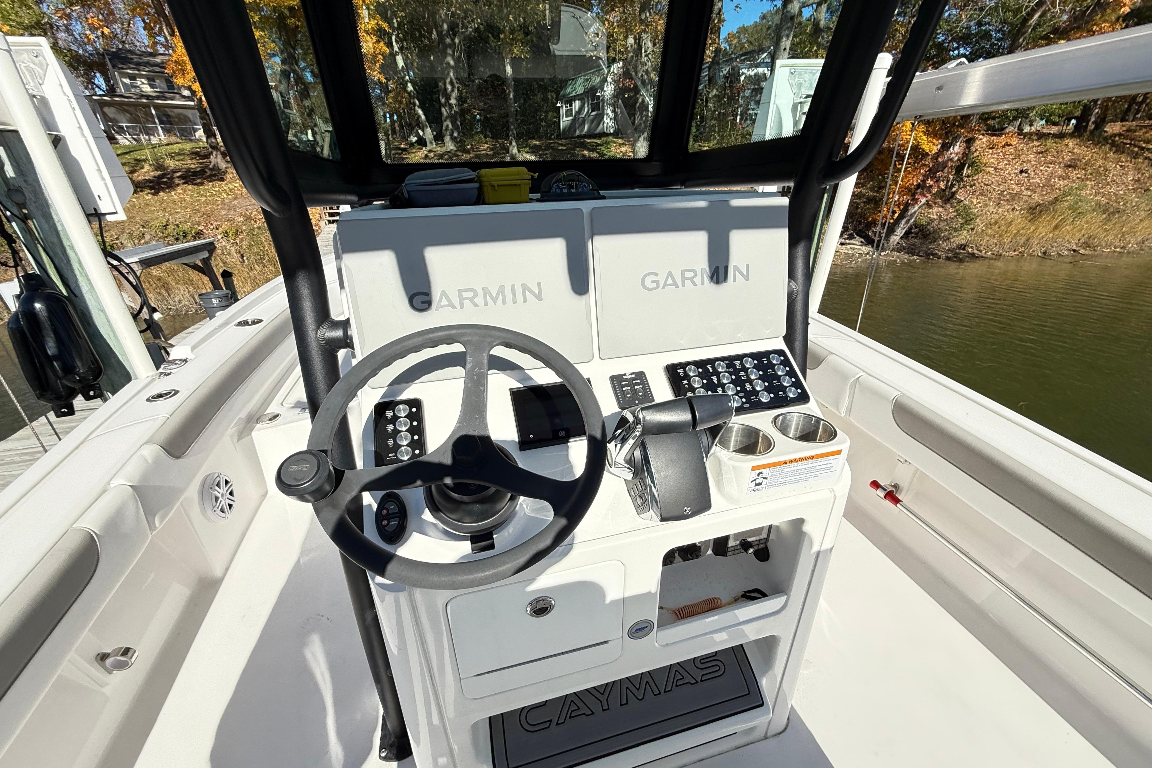 2023 Caymas 281 HB boat dashboard with Garmin navigation system and steering wheel.