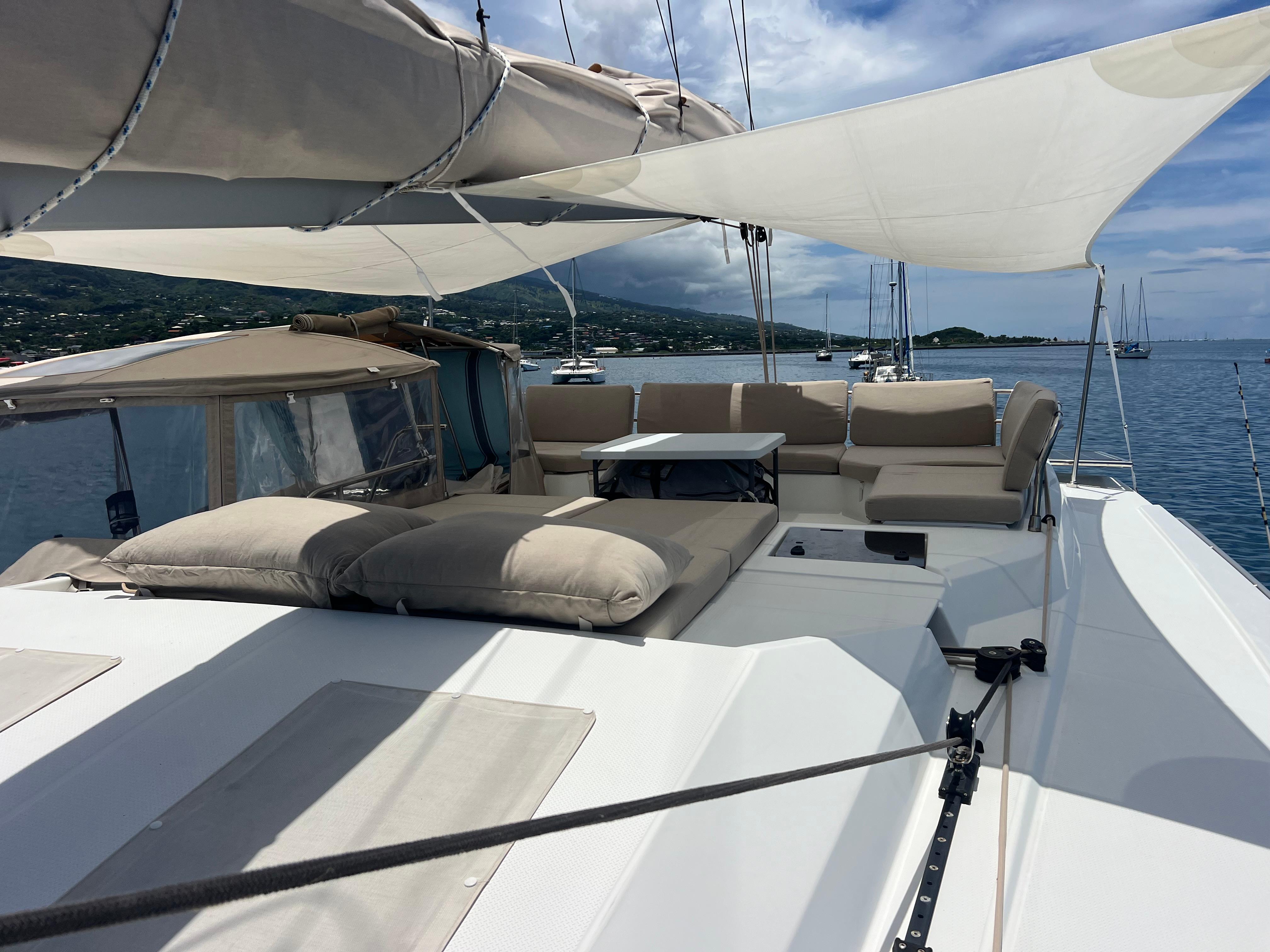 2022 Fountaine Pajot Elba 45 catamaran with spacious deck and seating, anchored in serene waters.