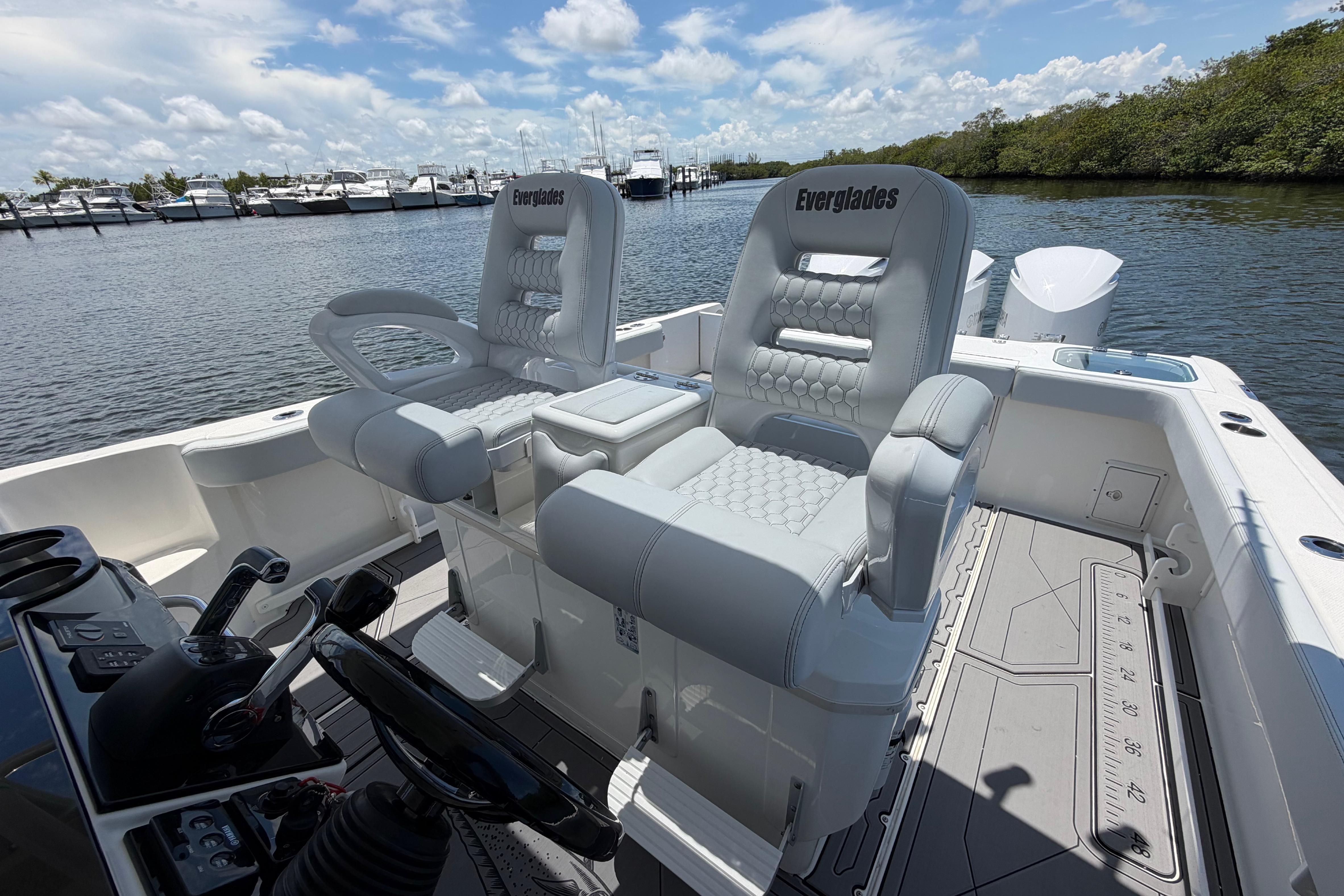 2009 Everglades 350LX boat interior with plush seating and scenic marina backdrop.