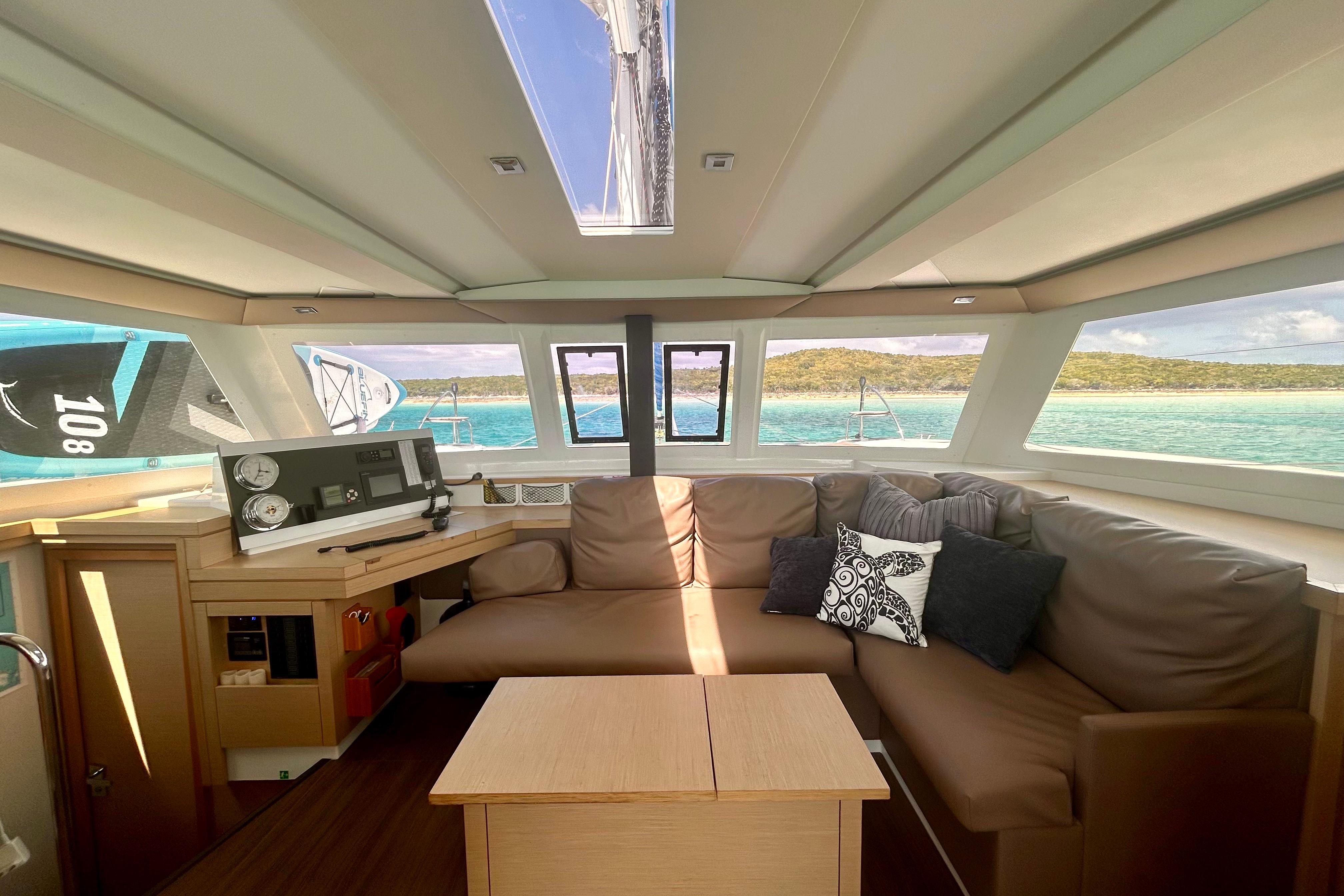 Interior of 2018 Fountaine Pajot Lucia 40 catamaran with comfortable seating and scenic ocean view.