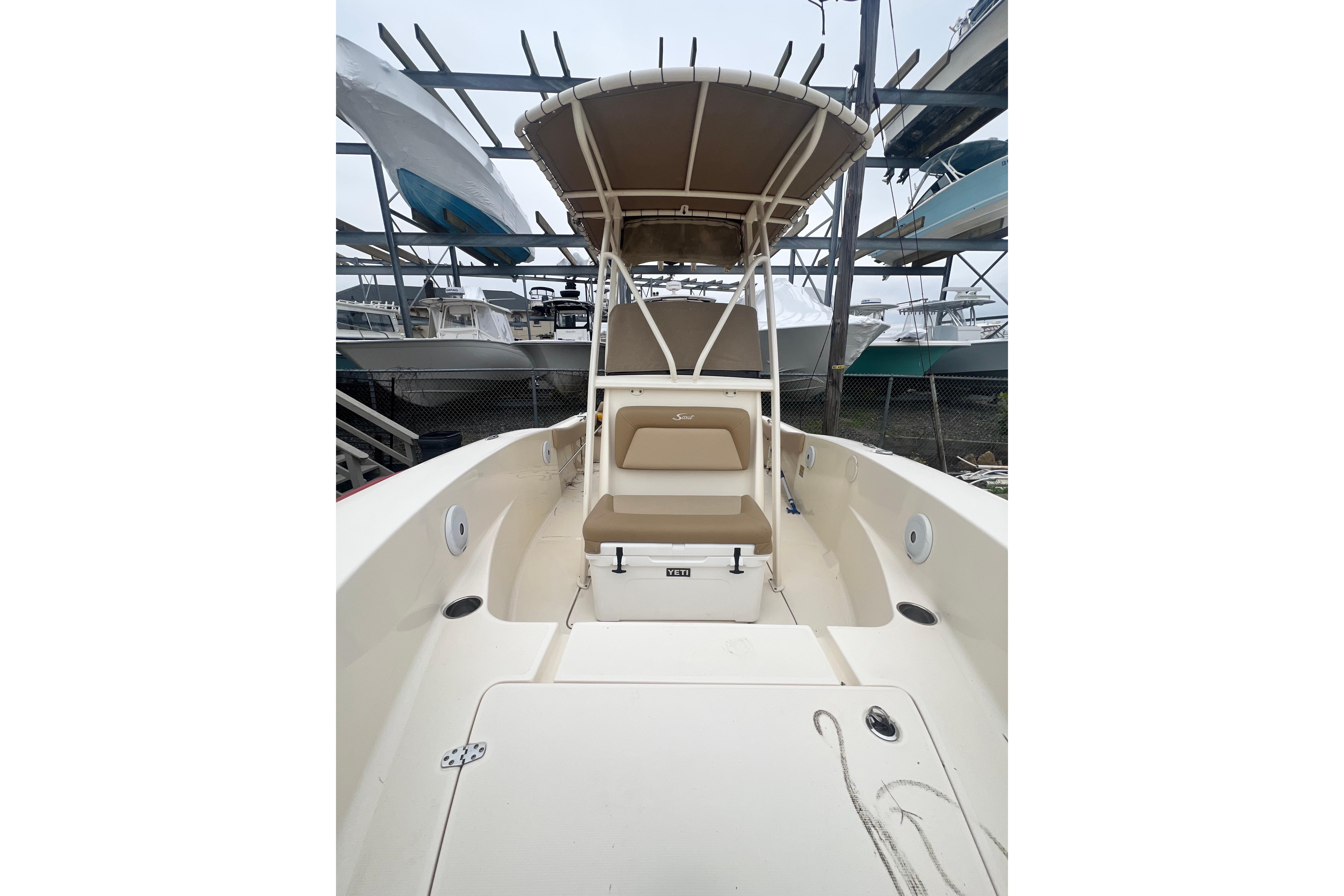 2020 Scout 195 Sportfish boat with seating and canopy in storage.