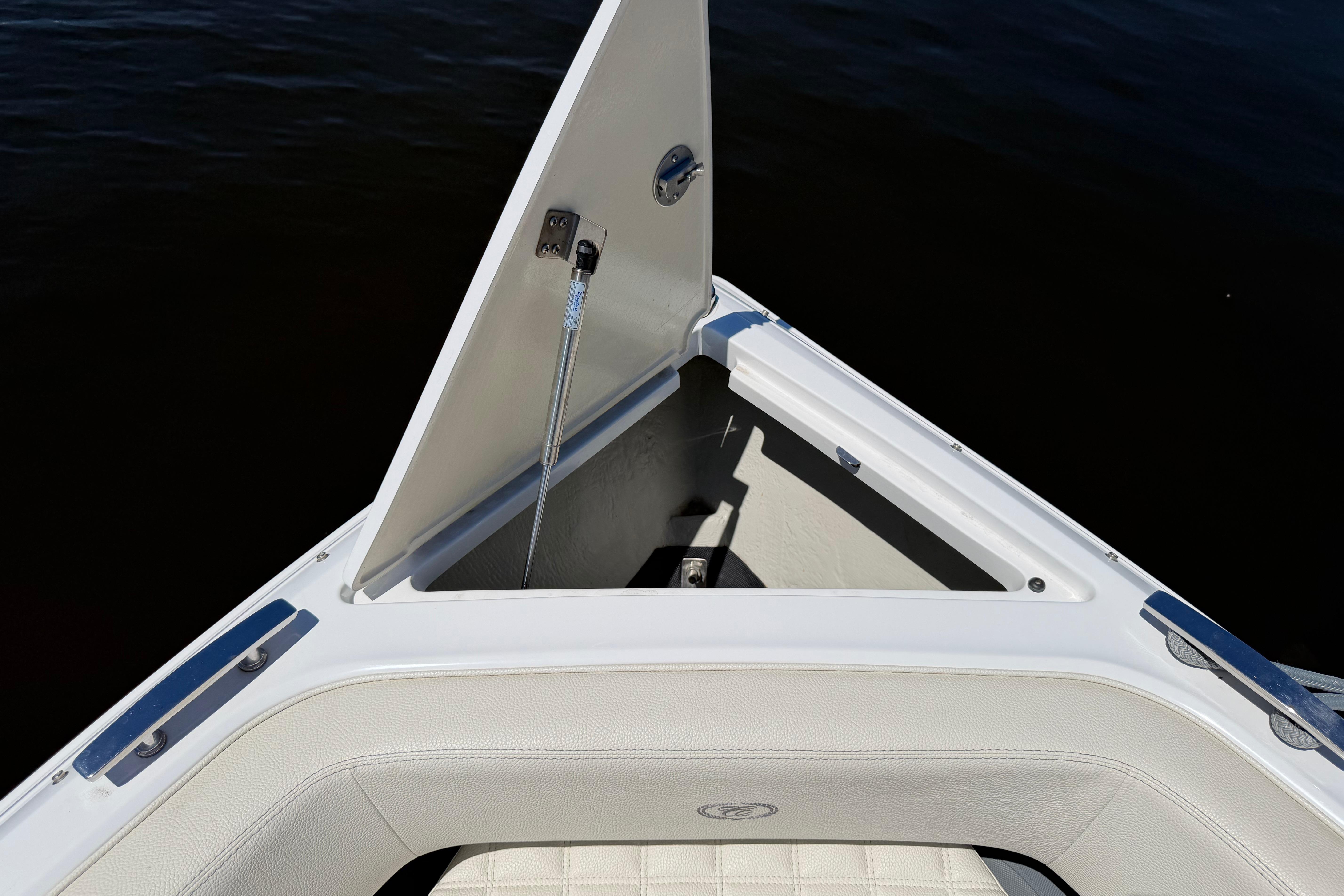 Open storage compartment on 2020 Cobalt R3 boat, featuring white cushioned seating.