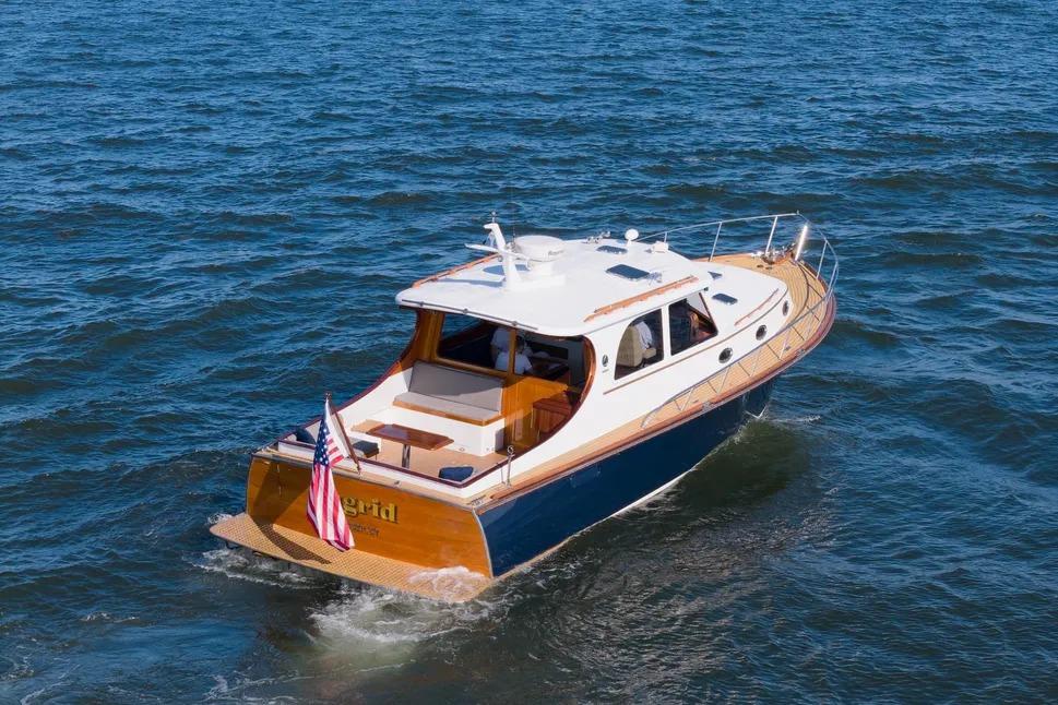 2007 Gorbon Custom Downeast 40 yacht cruising on open water, rear view.