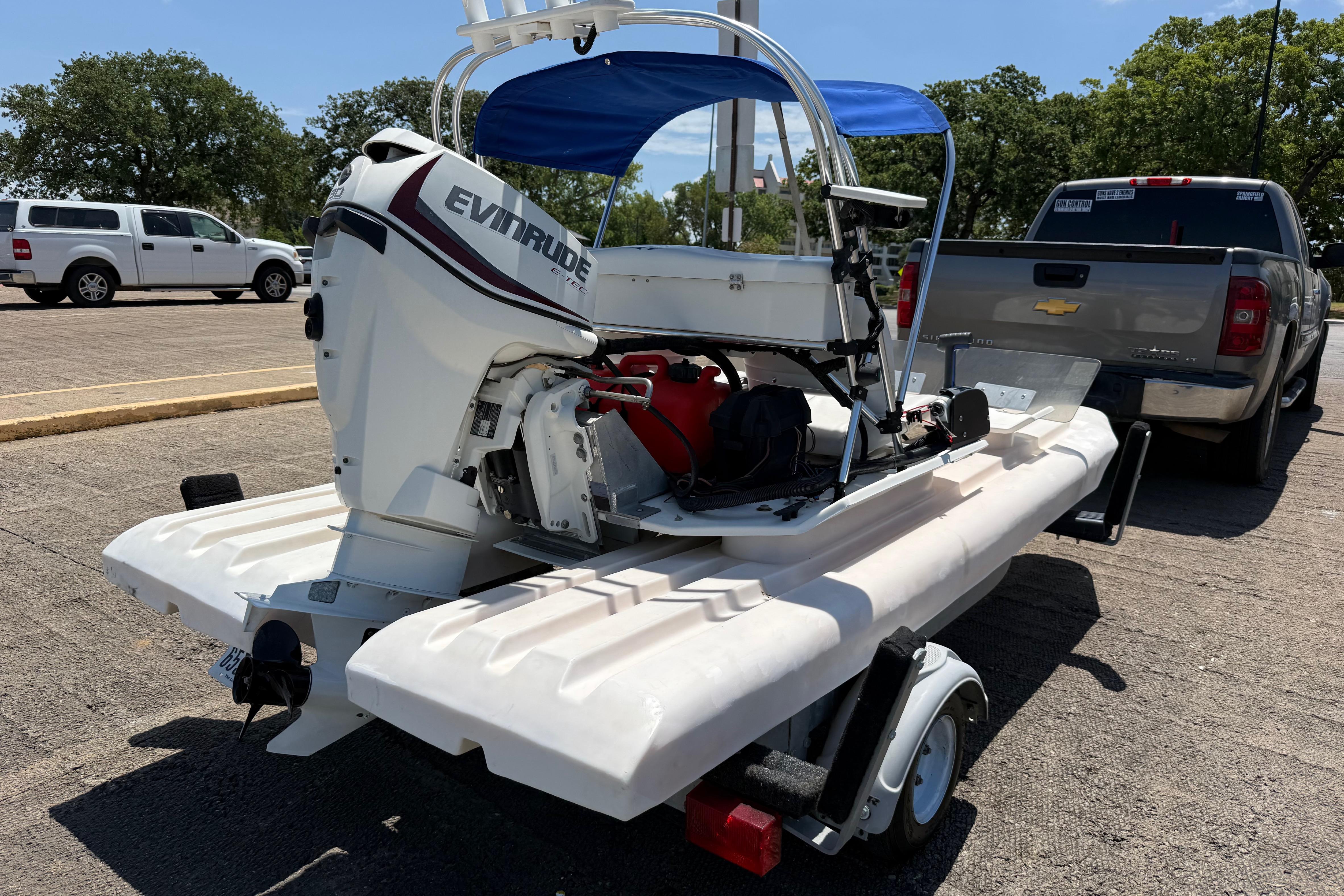 2016 CraigCat E2 Elite with Evinrude motor on trailer, parked near a pickup truck.