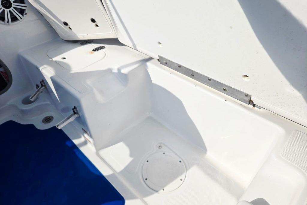 Interior view of a 2018 Tahoe 450 TS boat, showcasing white seating and storage compartments.
