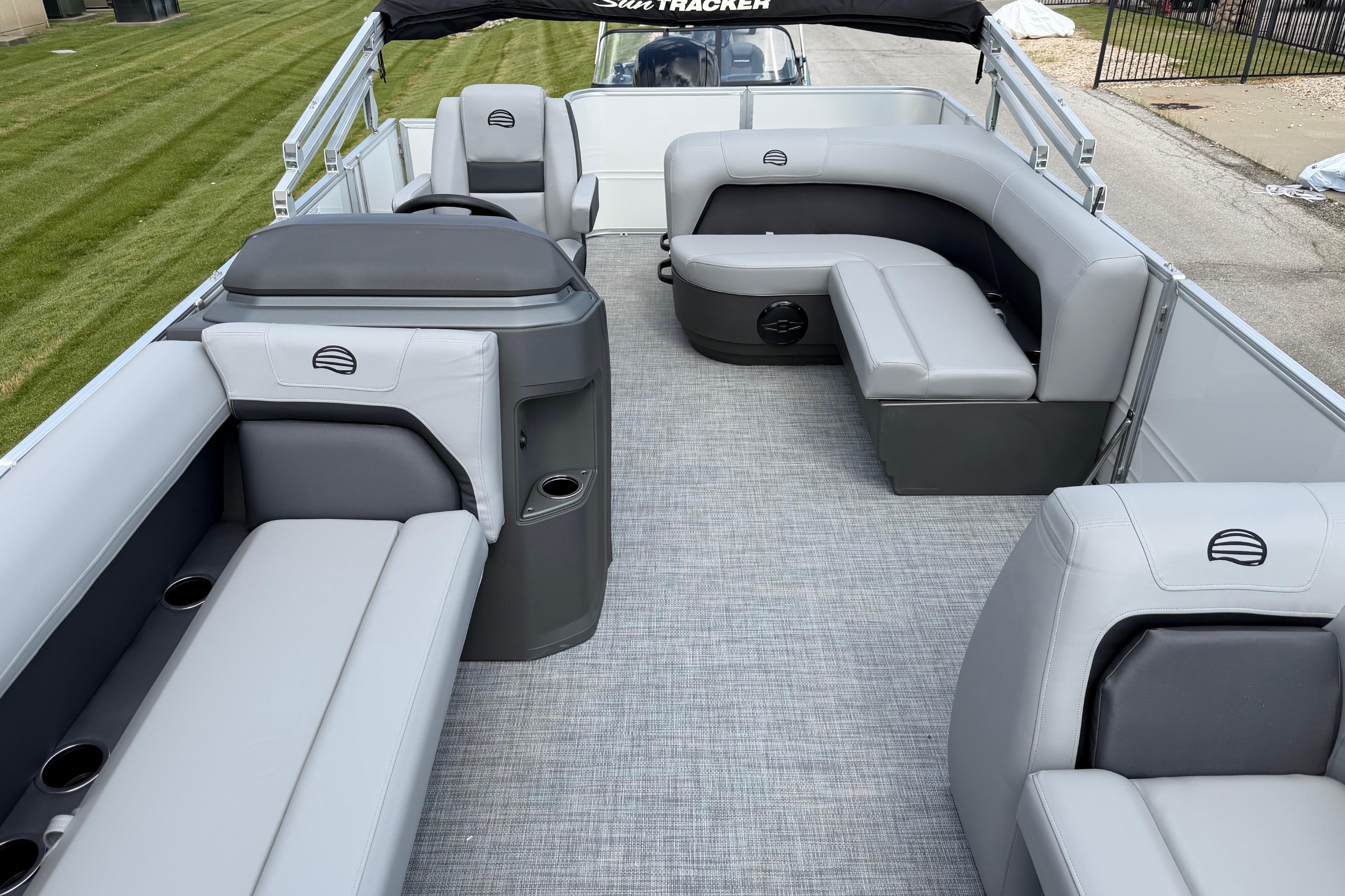 2026 Sun Tracker Party Barge 18 DLX interior with gray seating and spacious layout.