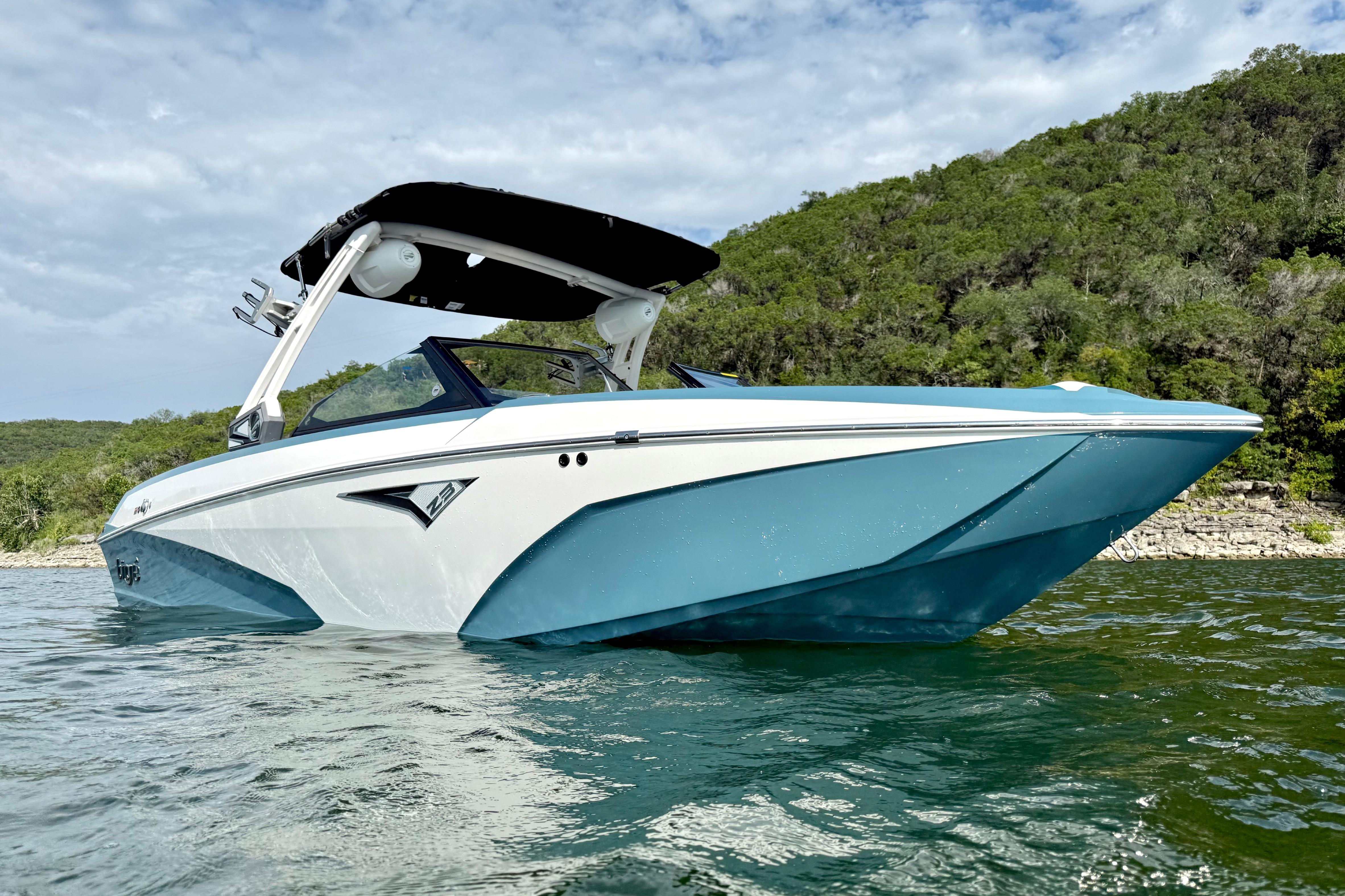 2021 Tige Z3 boat on a lake with lush green hills in the background.