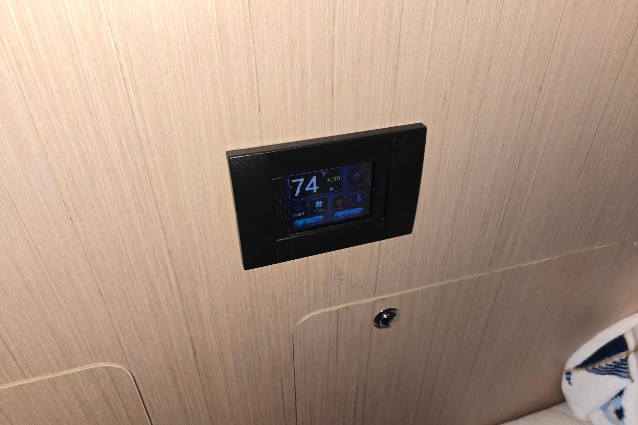 Digital control panel on 2023 Beneteau Oceanis 38.1 yacht interior.