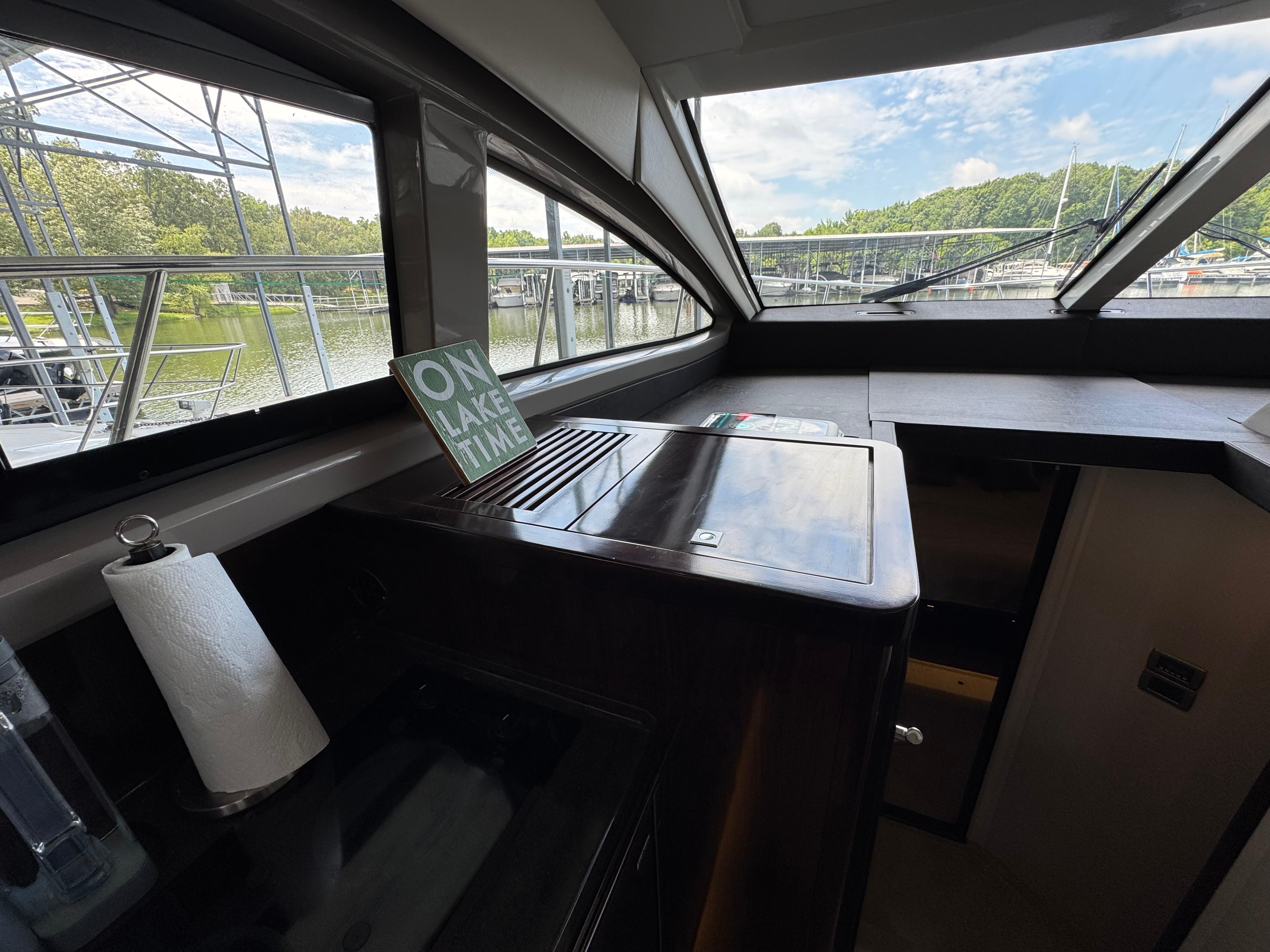 Interior of 2017 Sea Ray Sundancer 400 yacht with lake view and "On Lake Time" sign.