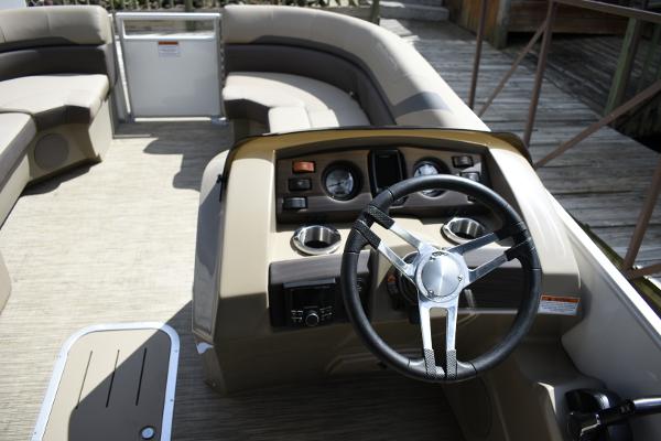 2023 Bennington 22 SXCW pontoon boat interior with steering console and seating.