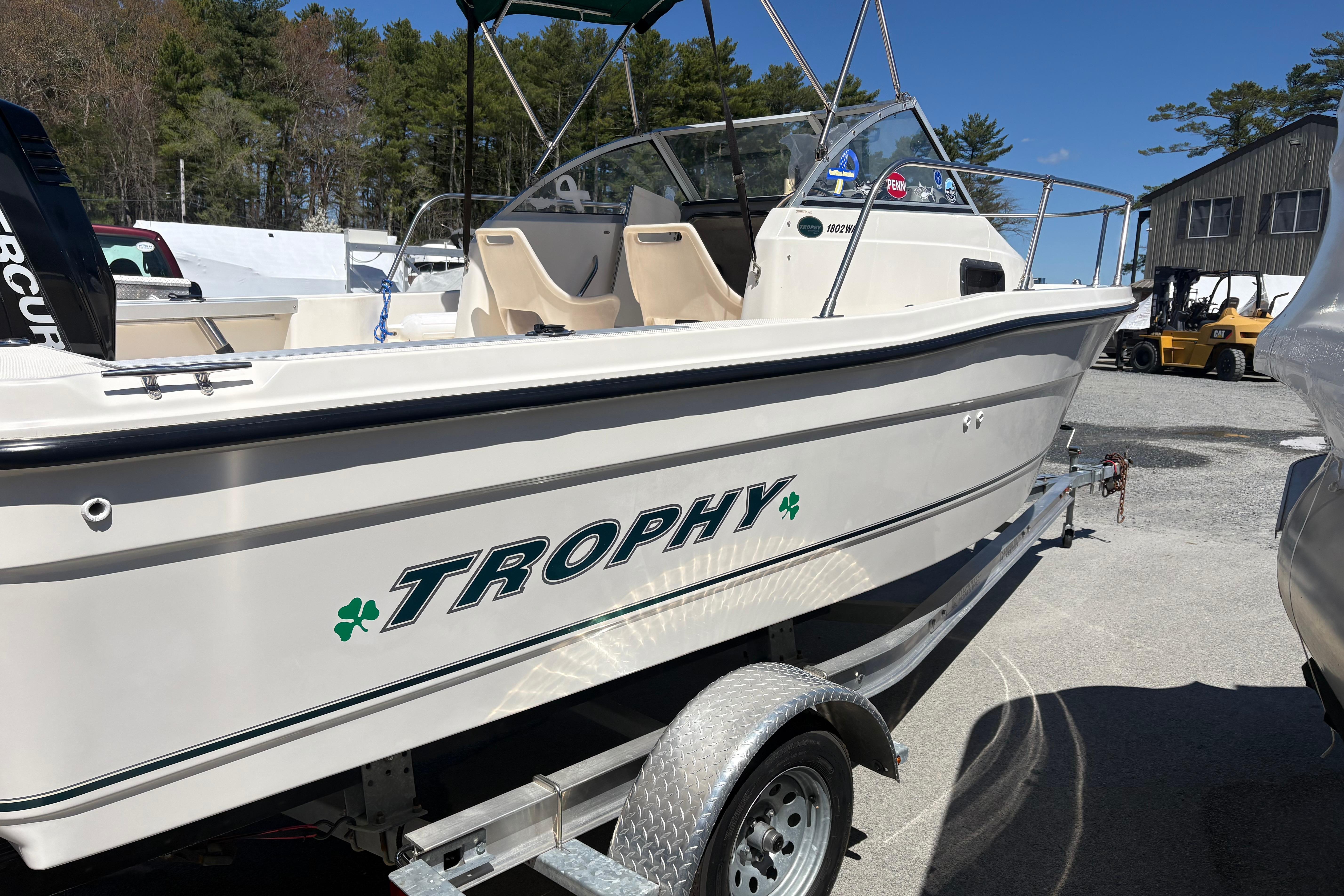 2004 Trophy 1802 Walkaround boat on trailer, parked outdoors under clear sky.