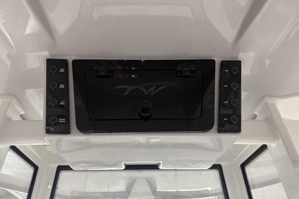 2026 Tidewater 2210 Carolina Bay boat console with control panel and storage compartment.