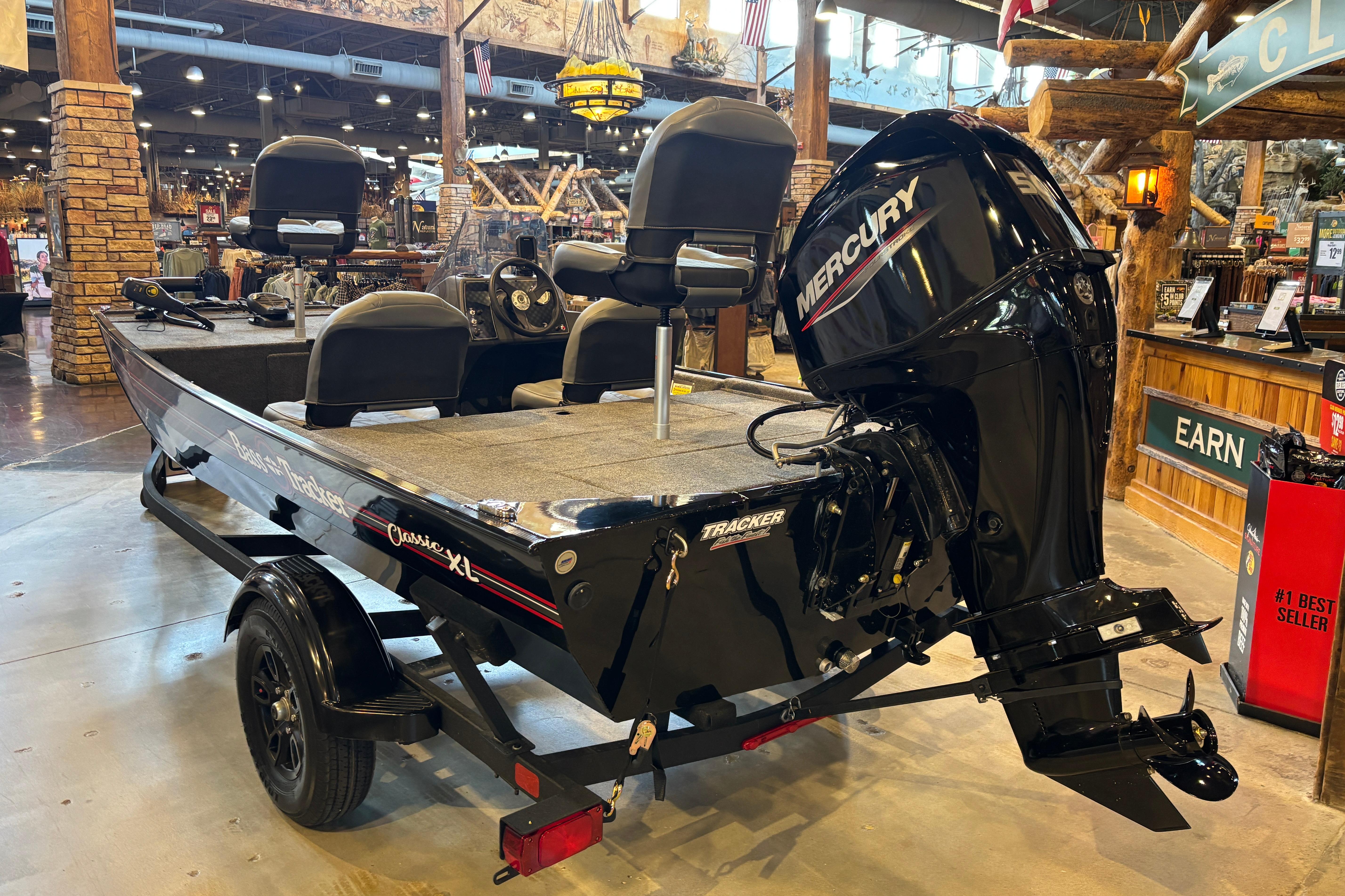 2026 Tracker Bass Tracker Classic XL boat with Mercury engine displayed indoors.